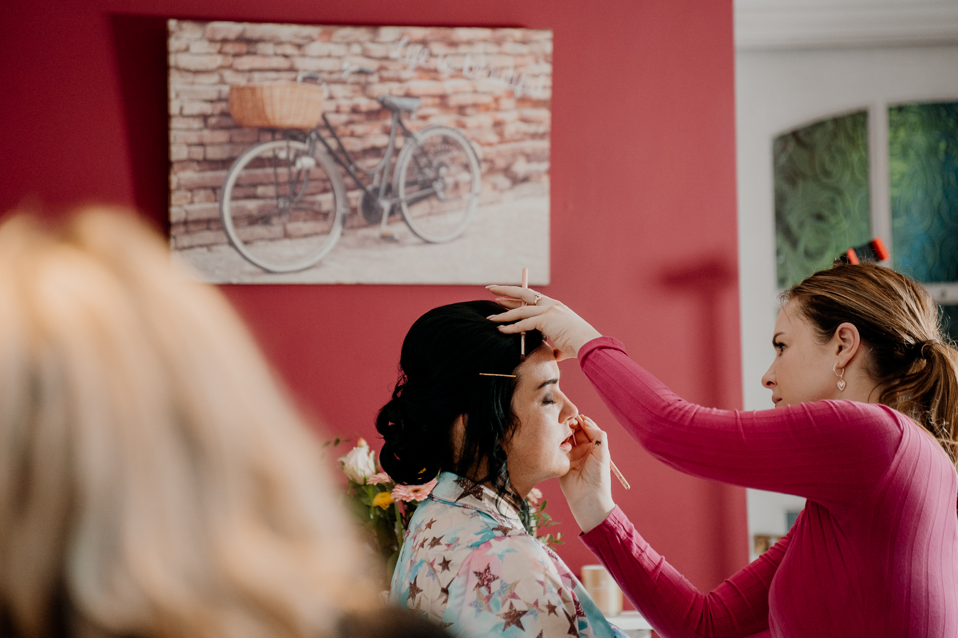 A person putting the hands on another woman's face