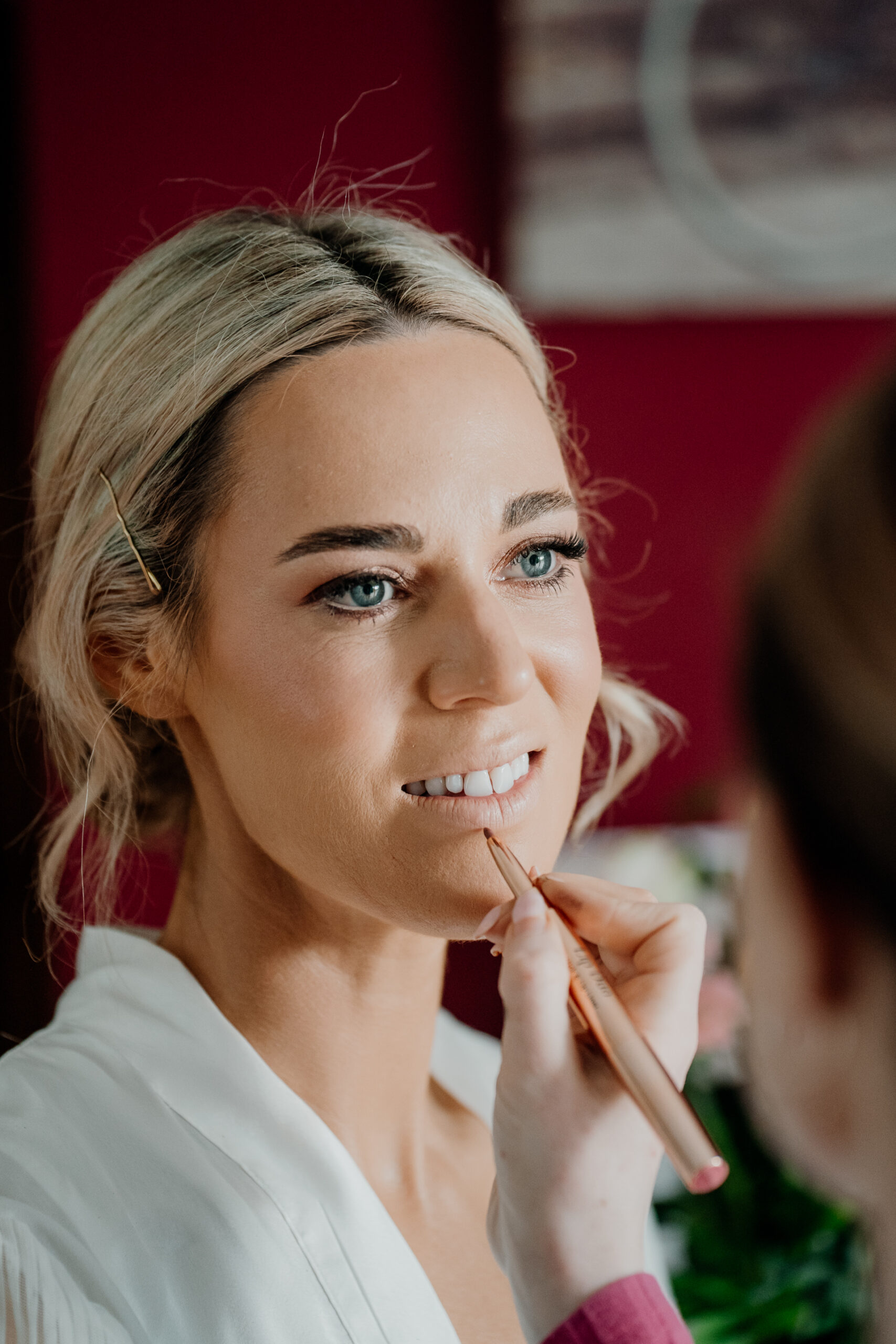 A woman smiling and holding her chin