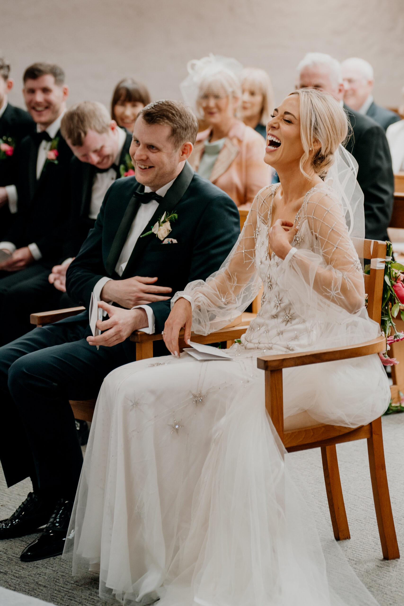 A man and woman sitting on a chair with a man in a suit