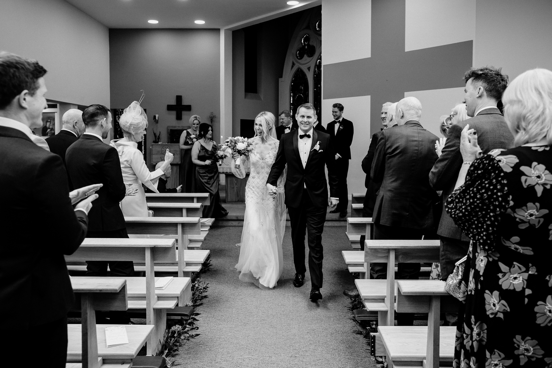 A bride and groom walking down the aisle