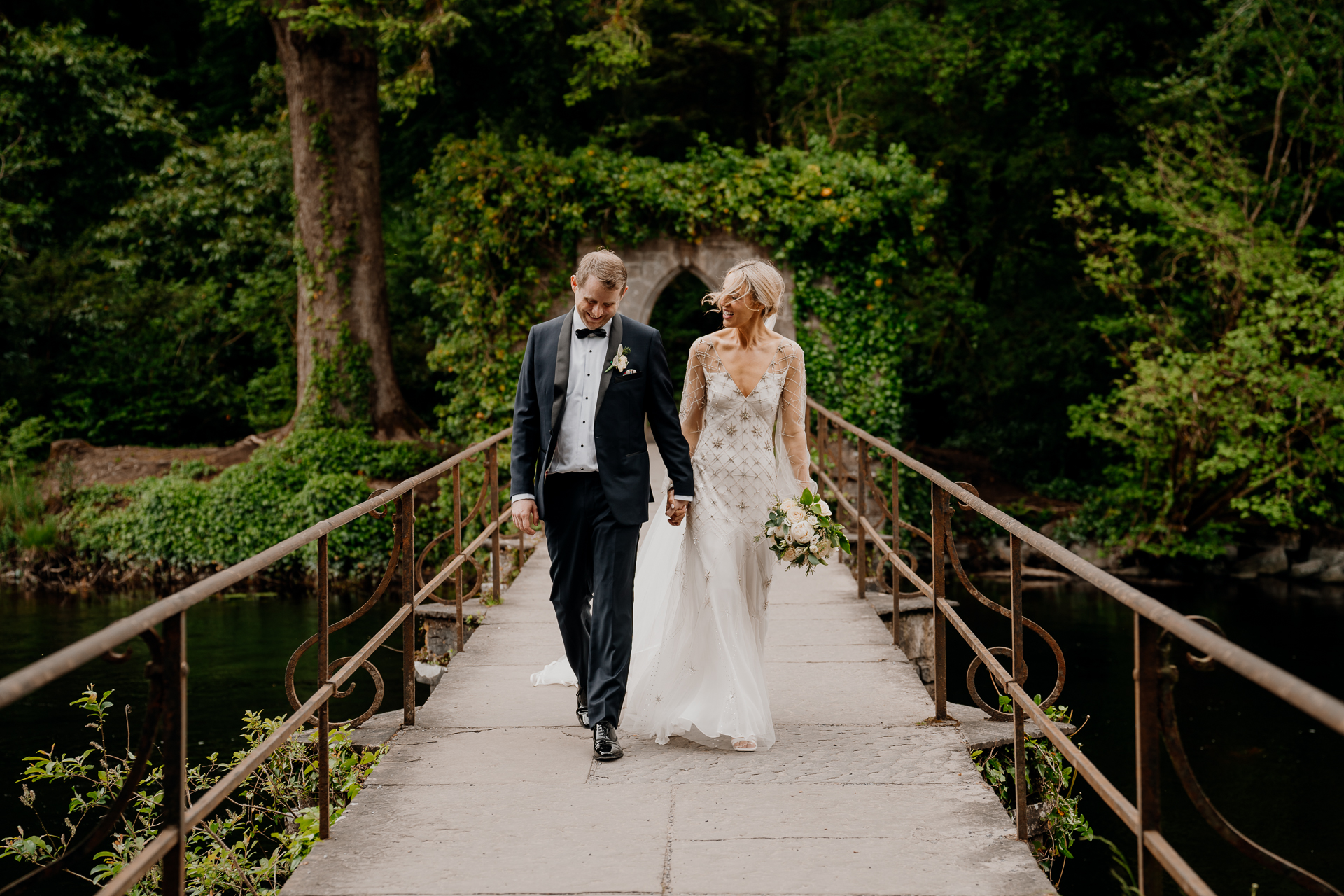 A man and woman walking on a bridge