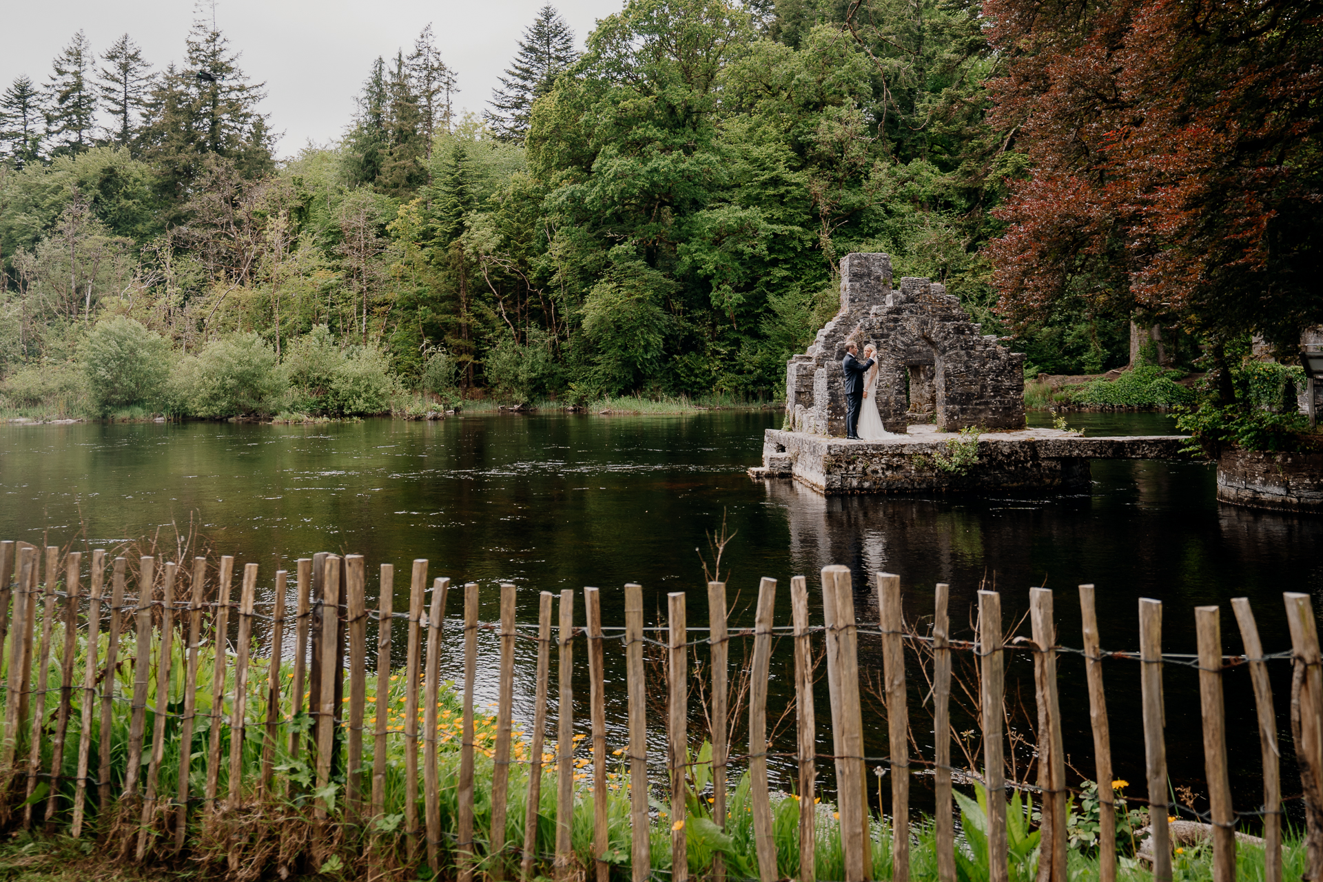 A fence in front of a lake