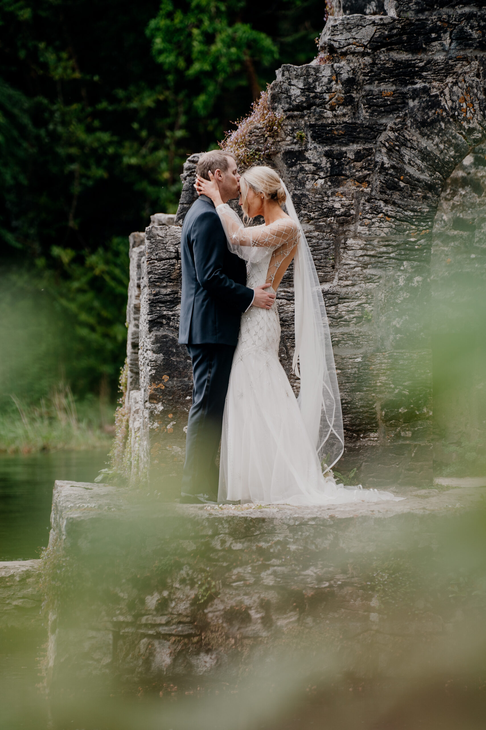 A man and woman kissing in a waterfall