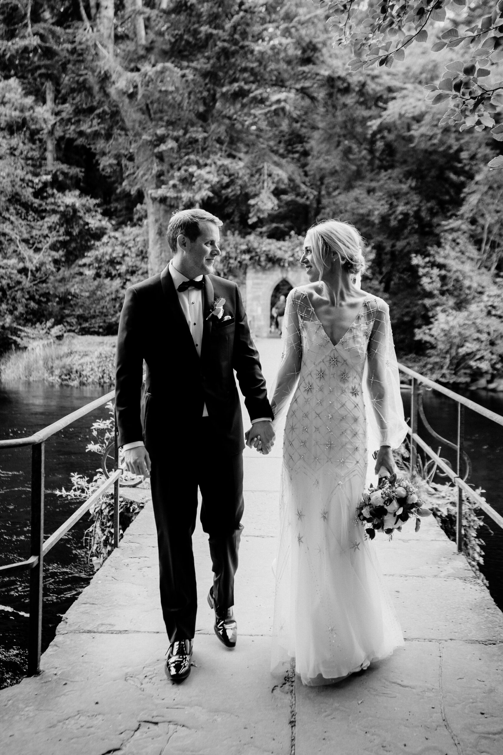 A man and woman walking down a bridge