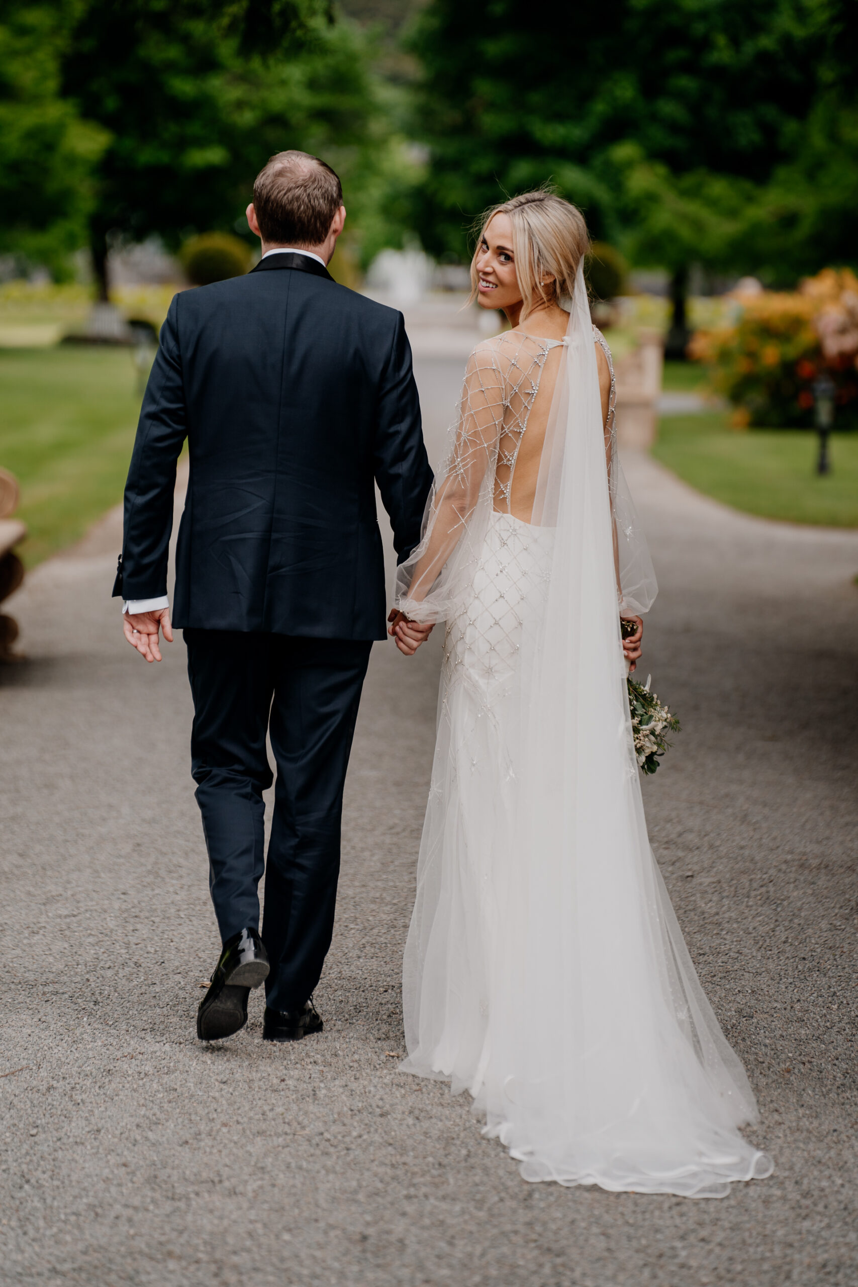 A man and woman walking down a road