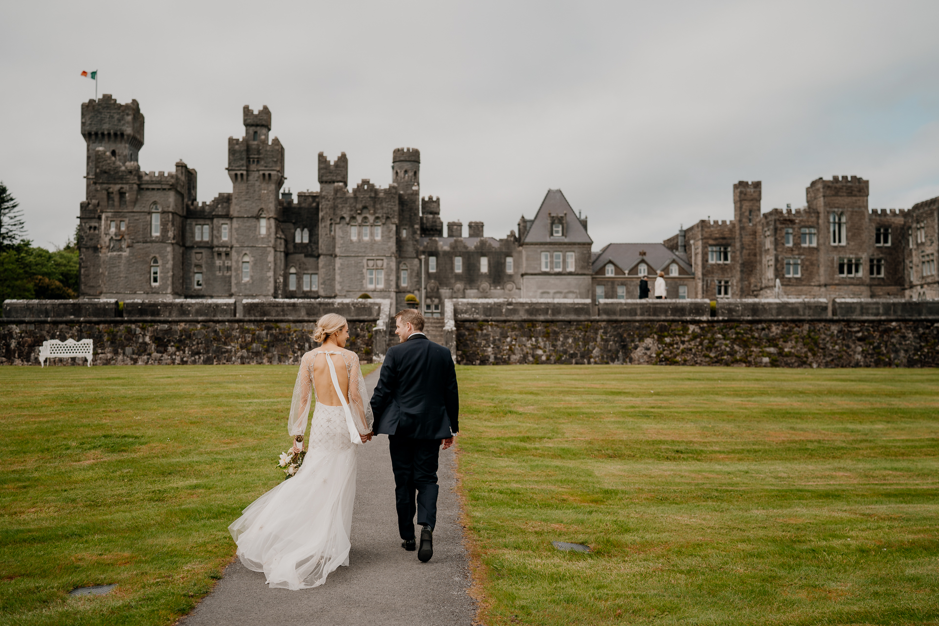 A man and woman walking towards a castle