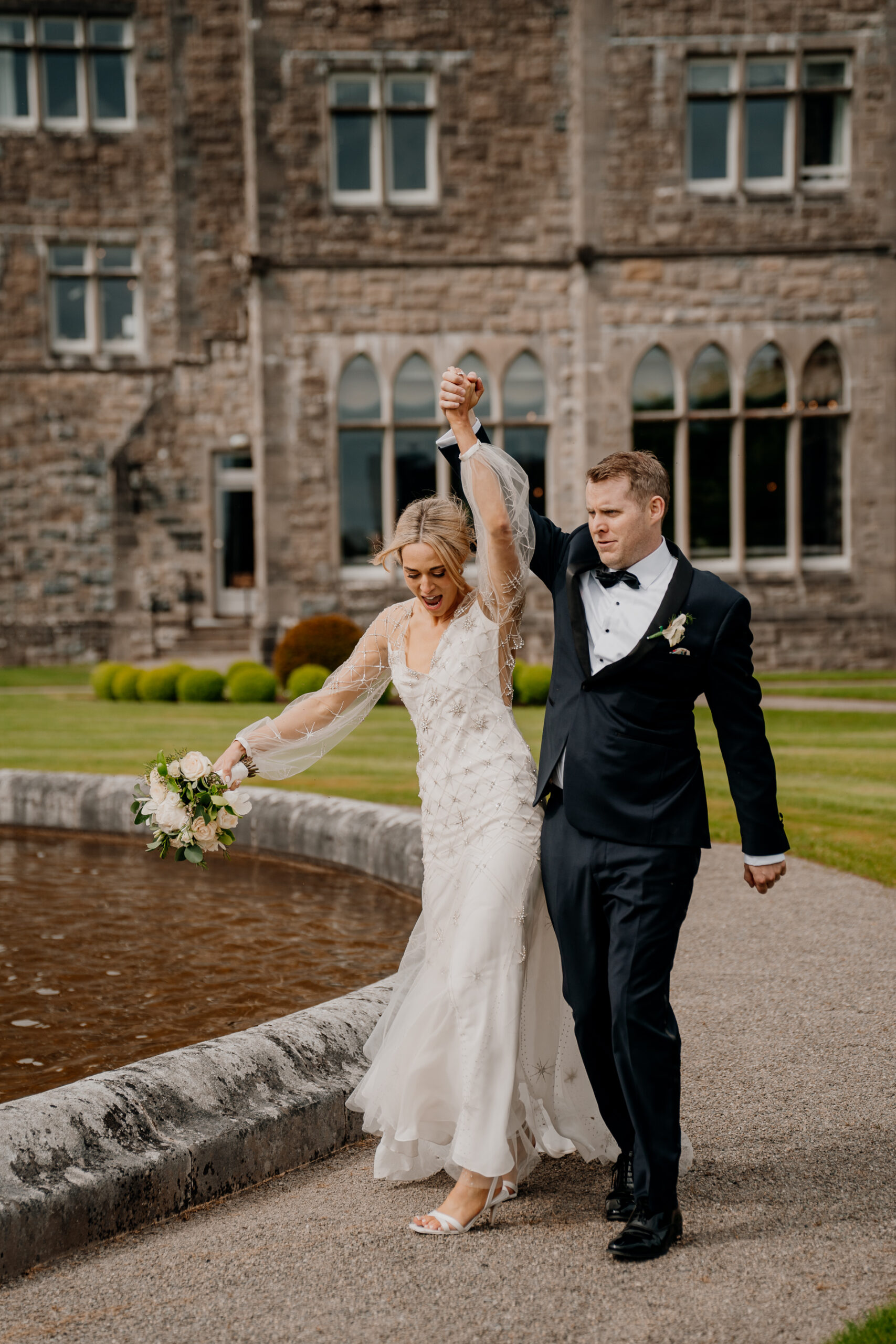 A man and woman posing for a picture next to a fountain