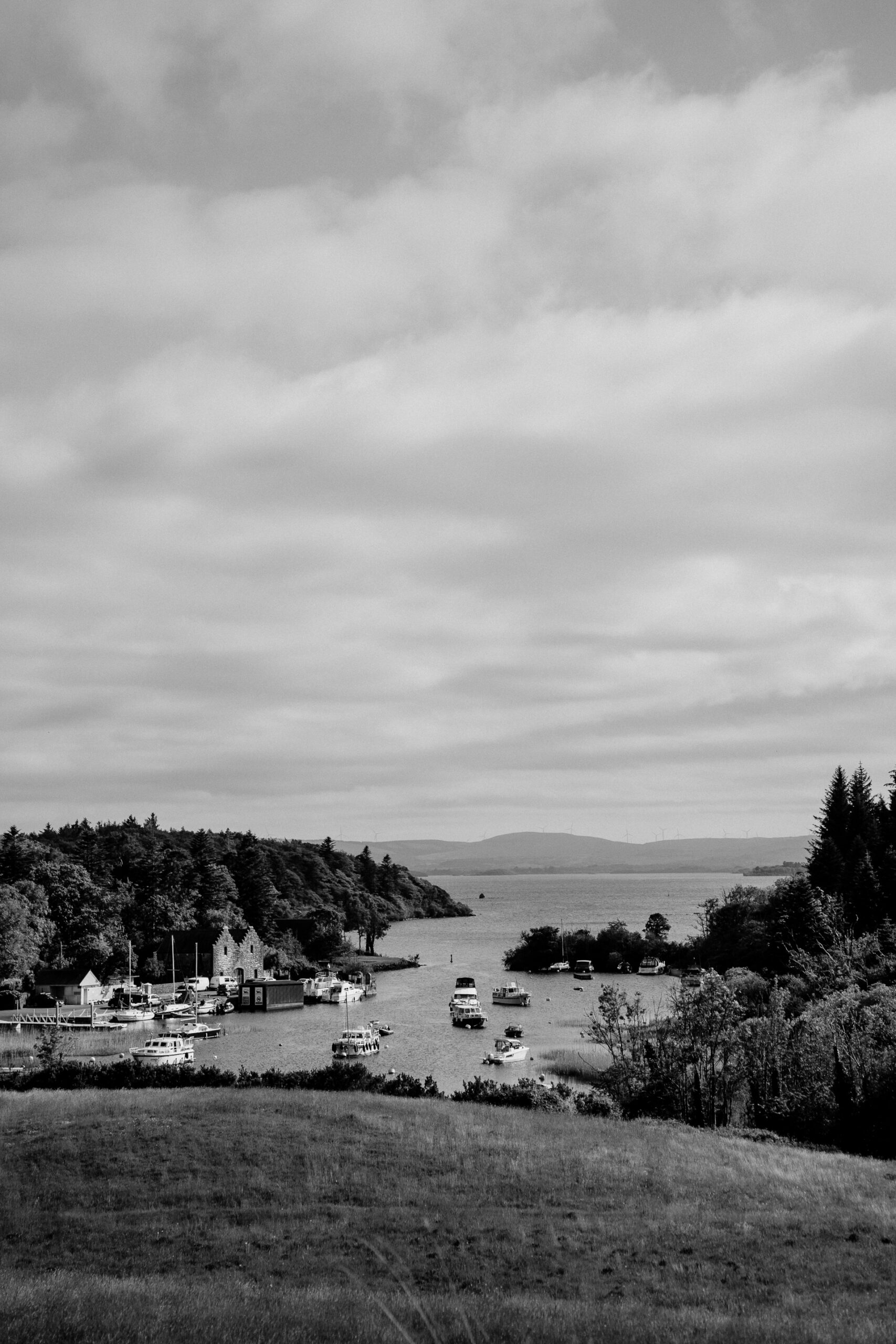 A black and white photo of a town by a lake