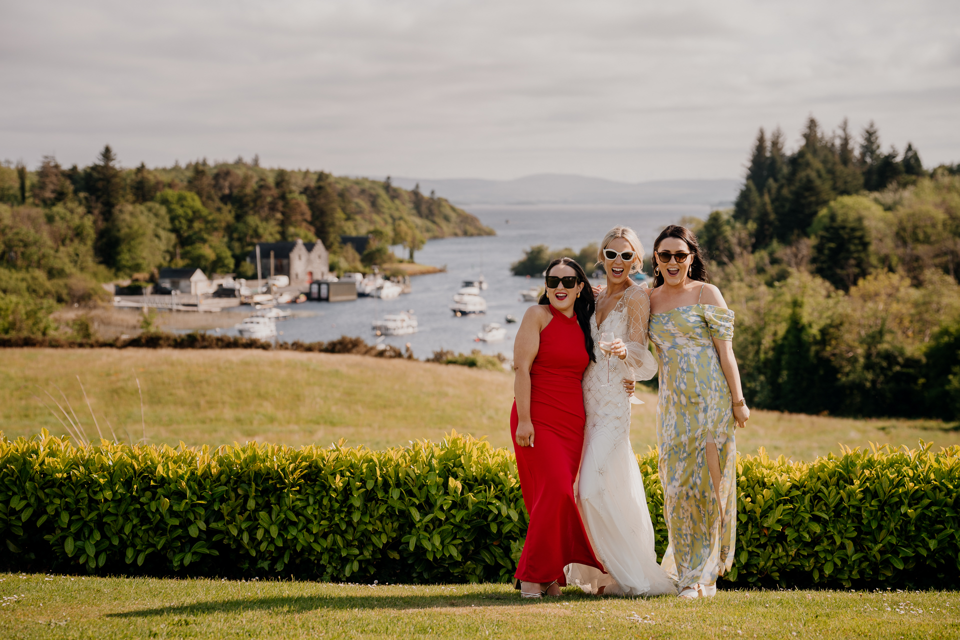 A group of women posing for a picture in front of a lake