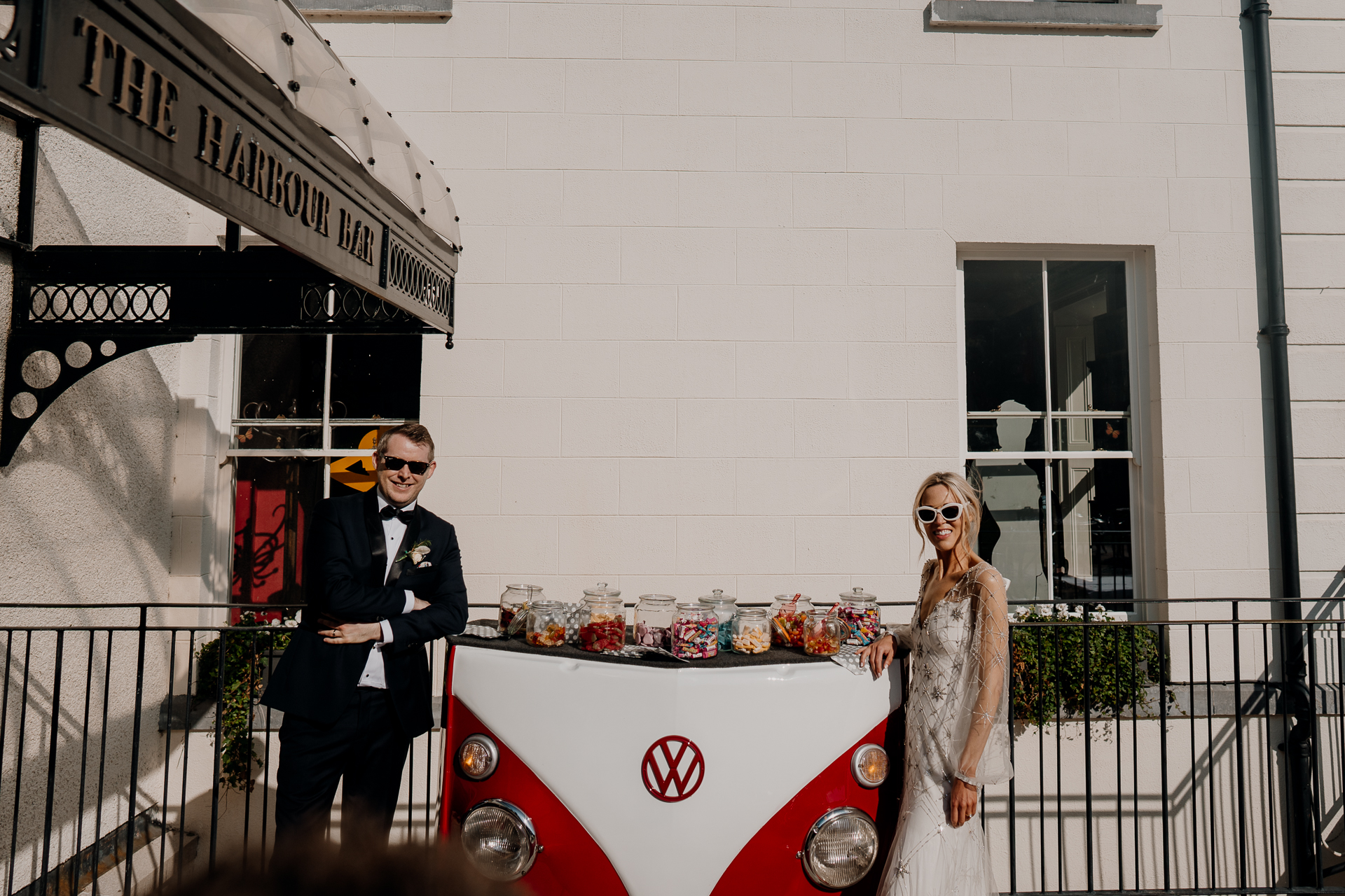 A man and woman standing next to a car with a cartoon character on it