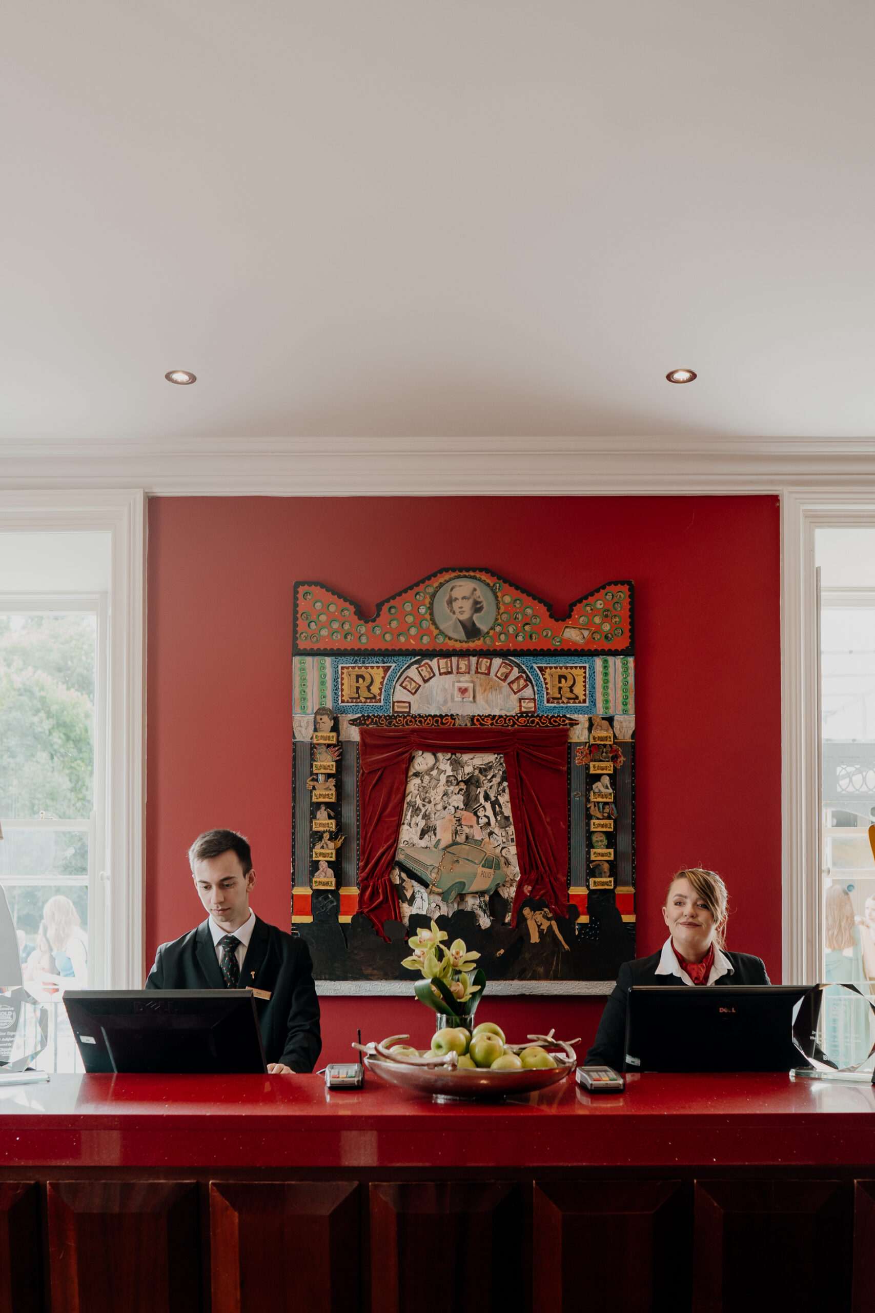 A man and a woman sitting at a table with laptops