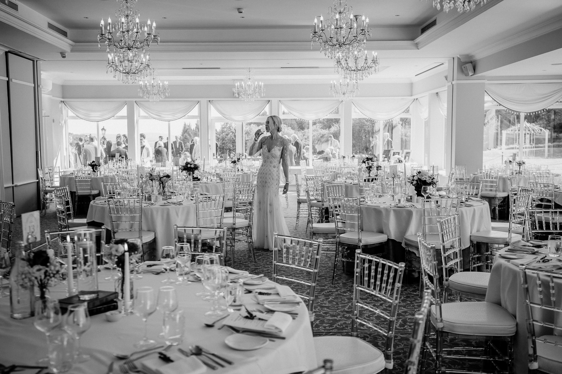 A person standing in a room with tables and chairs