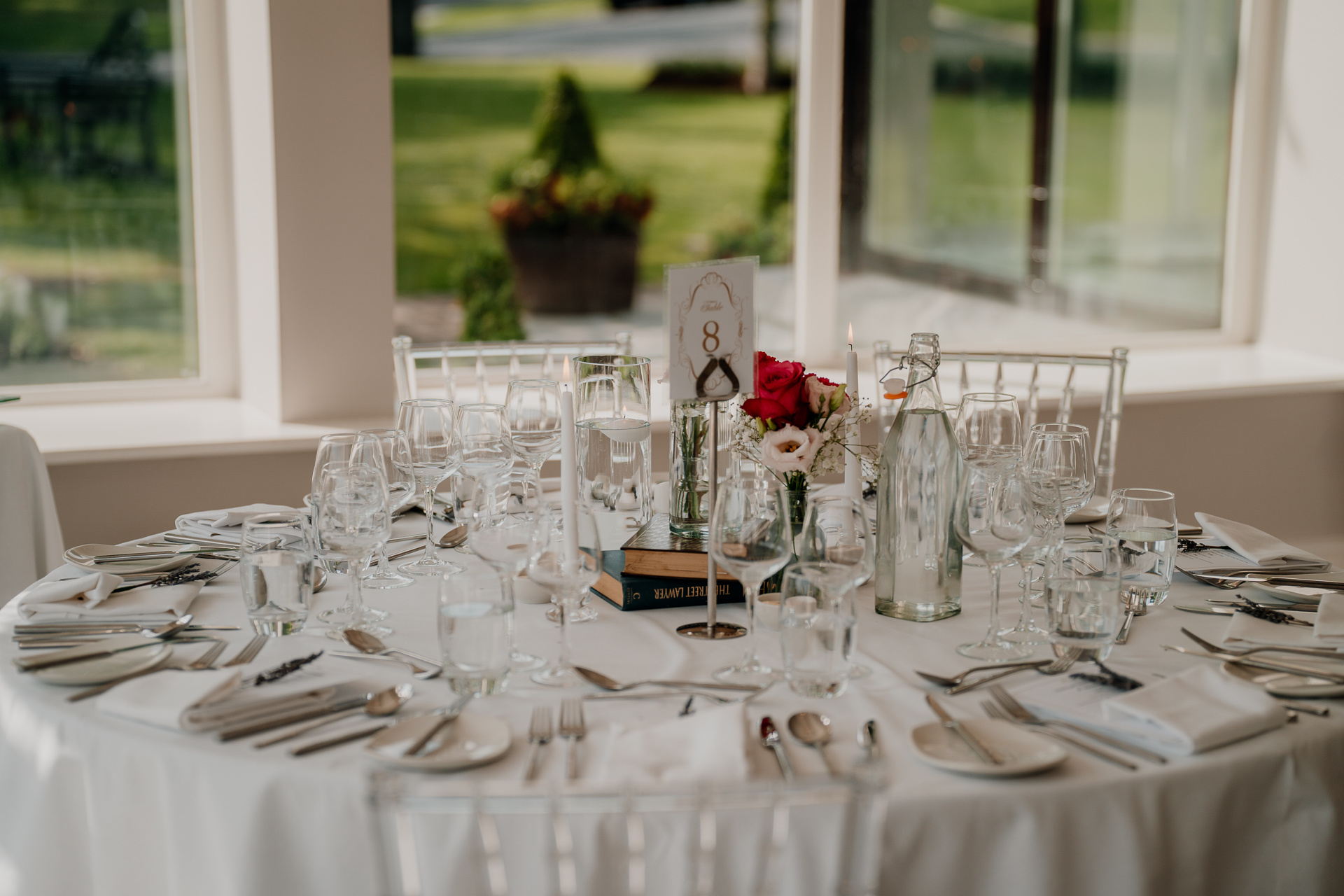 A table with a set of glasses and a bouquet of flowers