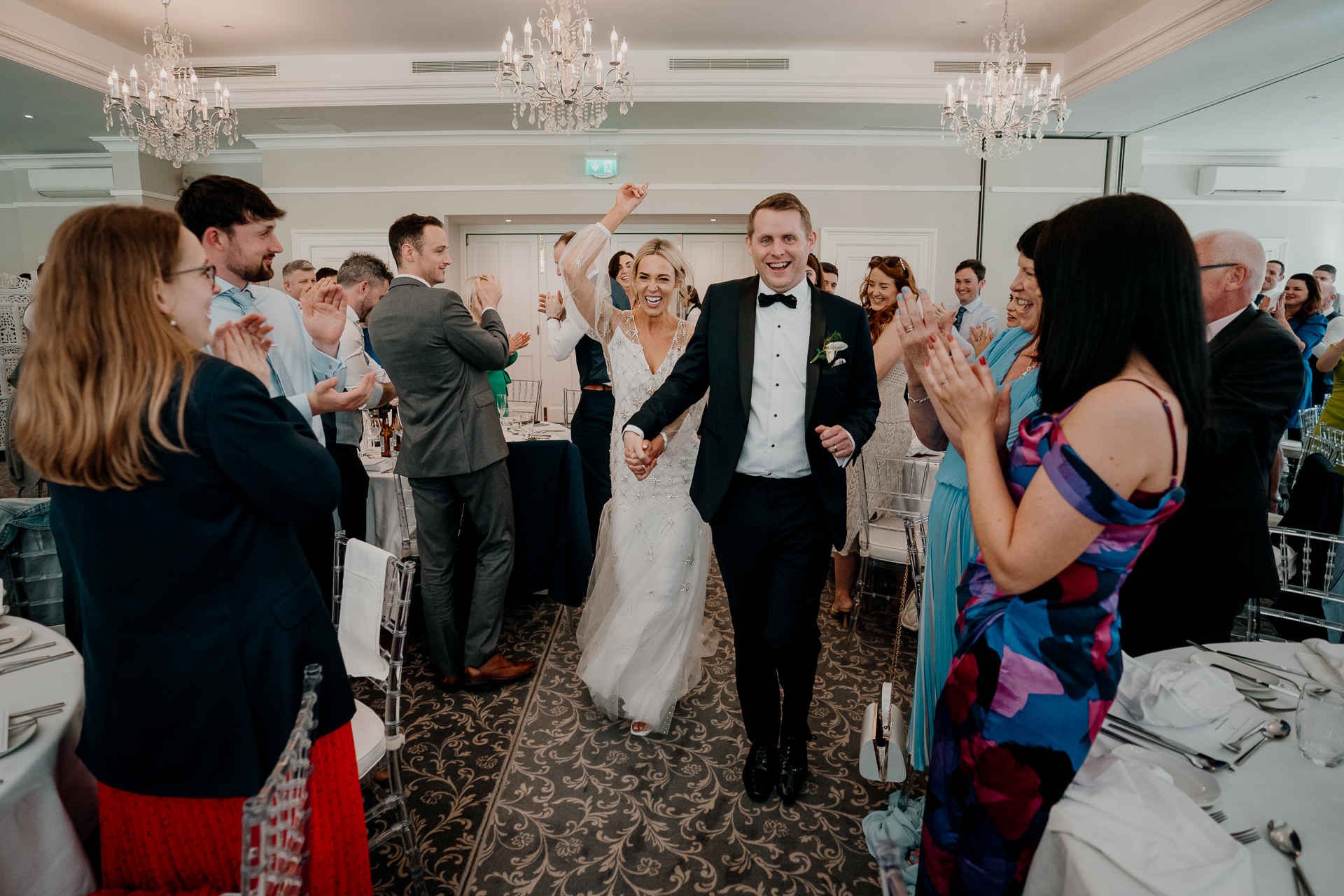 A man and woman dancing in a room full of people