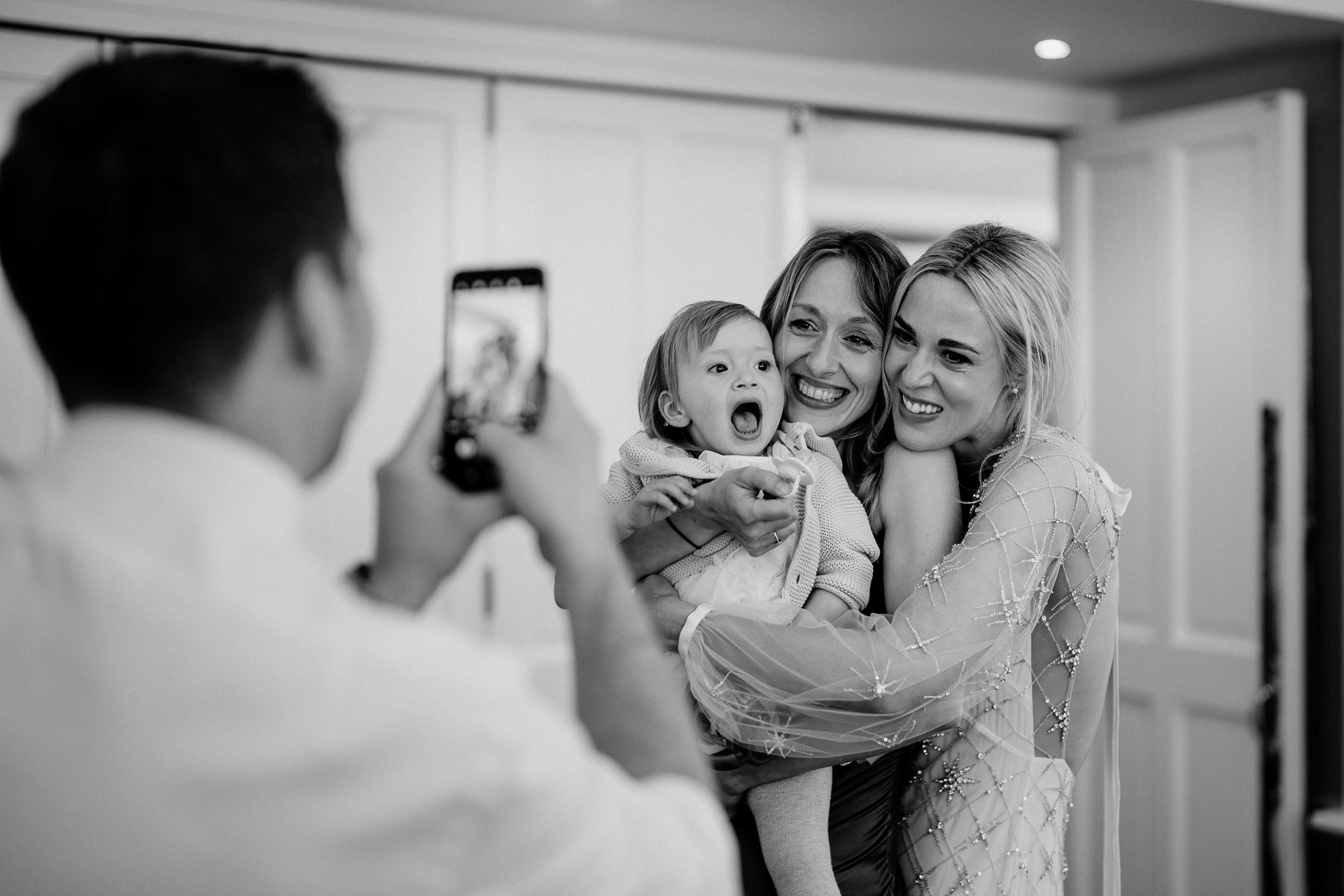 A woman taking a picture of a group of women