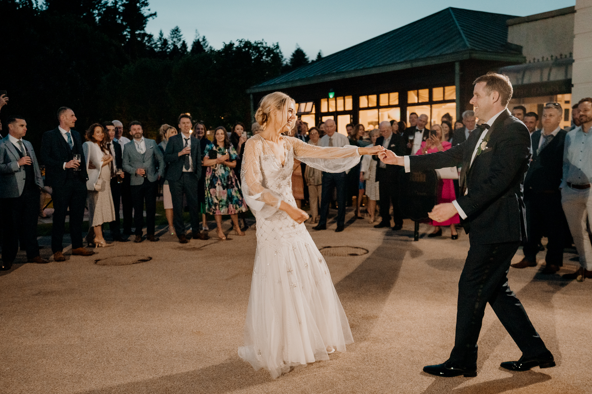 A man and woman dancing in front of a crowd of people