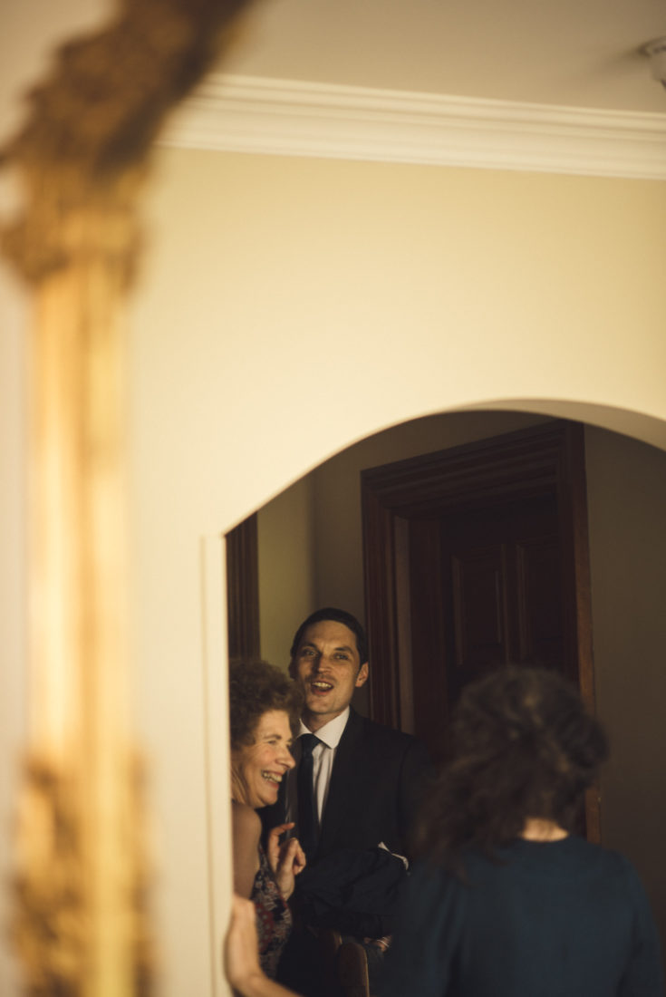 A man and a woman standing in front of a mirror