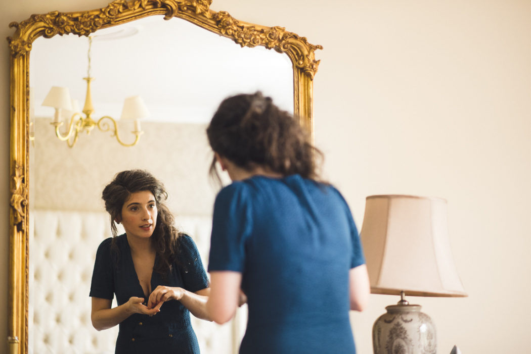 A person standing in front of a mirror posing for the camera
