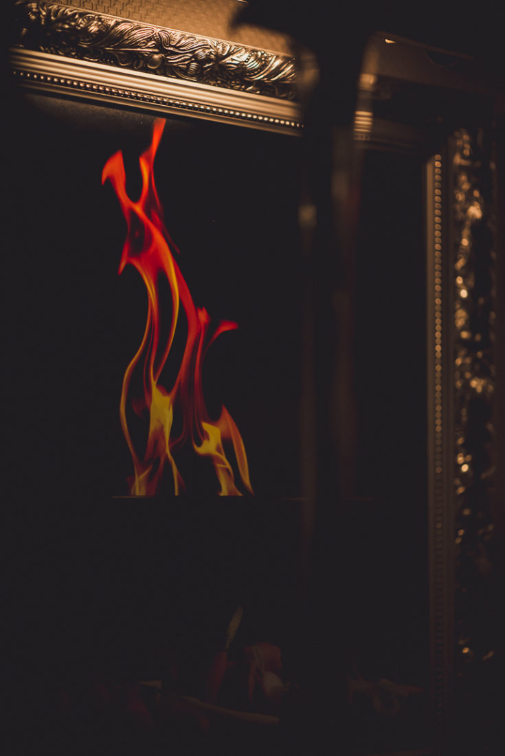 A close up of a fire place sitting in a dark room