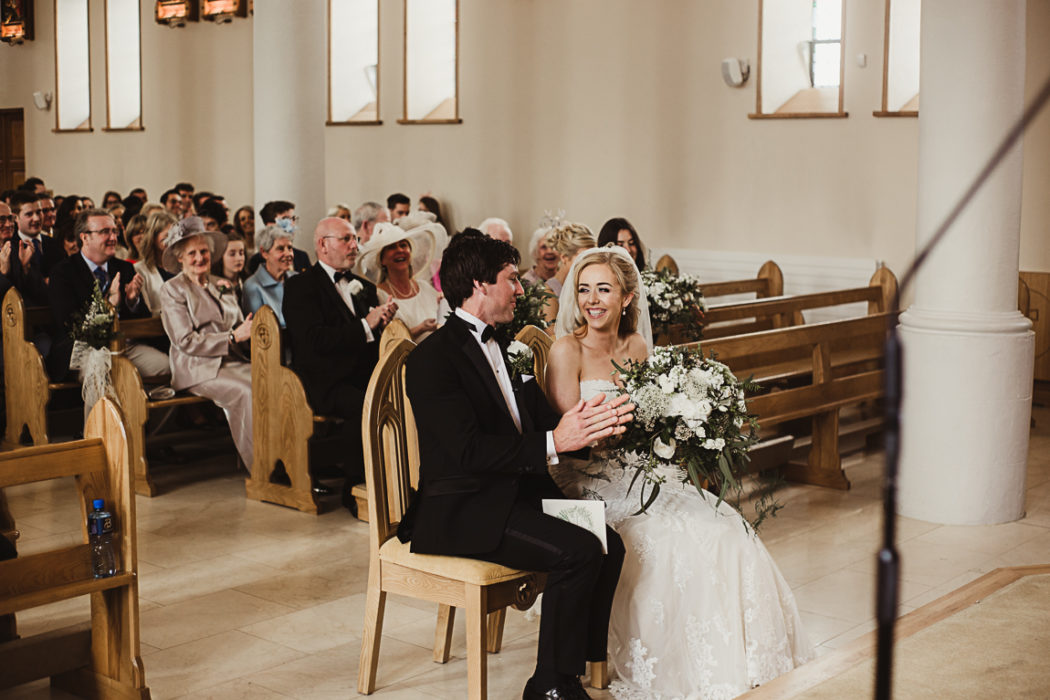 Bride and groom sitting in church