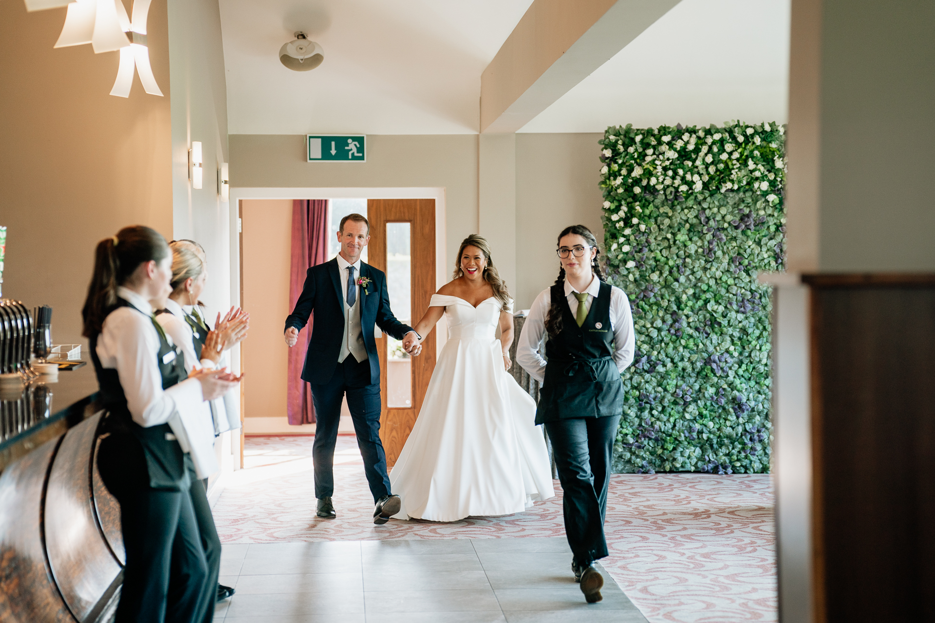 A group of people walking down a hall