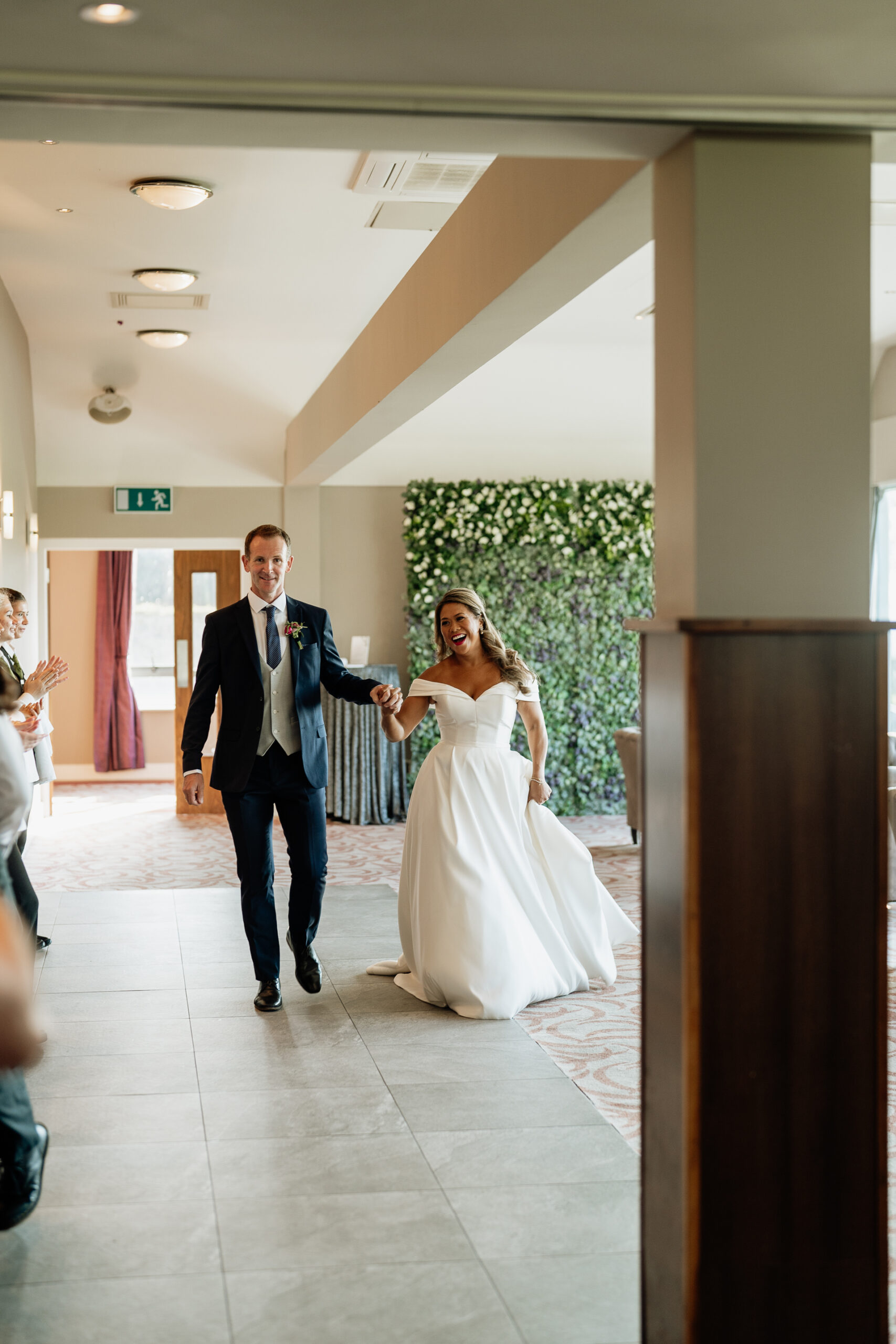 A man and woman walking down a hall