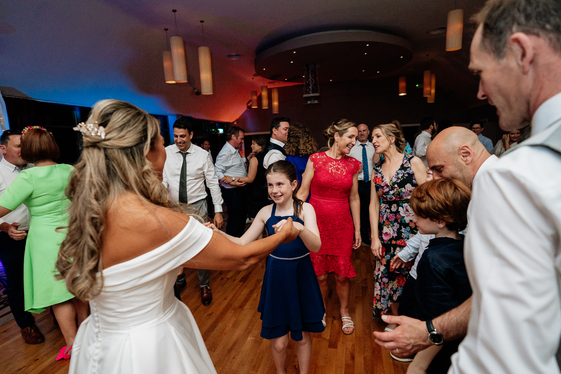 A man and woman dancing in a room full of people