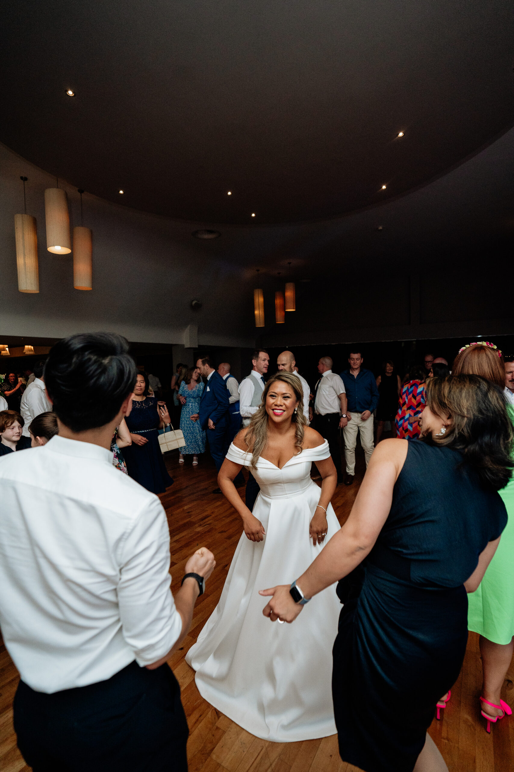 A woman in a white dress dancing with a man in a white dress