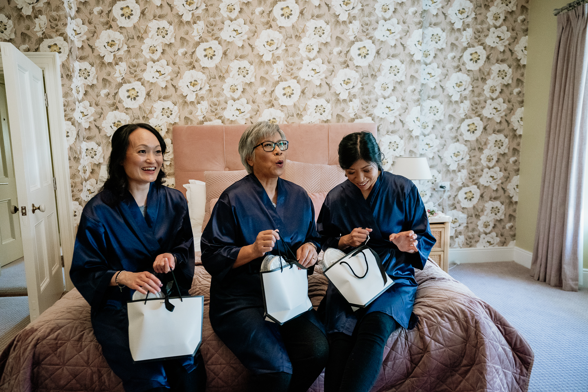 A group of women sitting on a bed