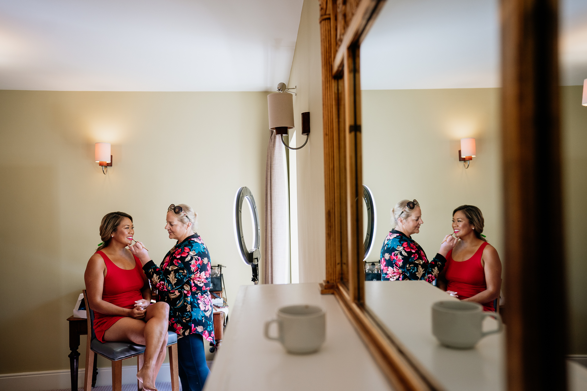 A group of women sit in a bathroom