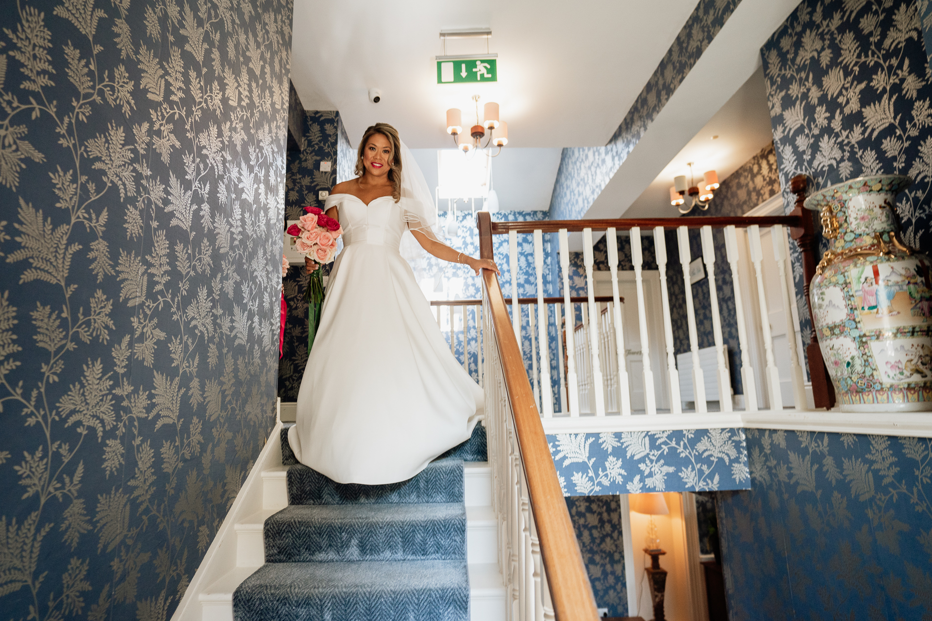 A person in a white dress on a staircase