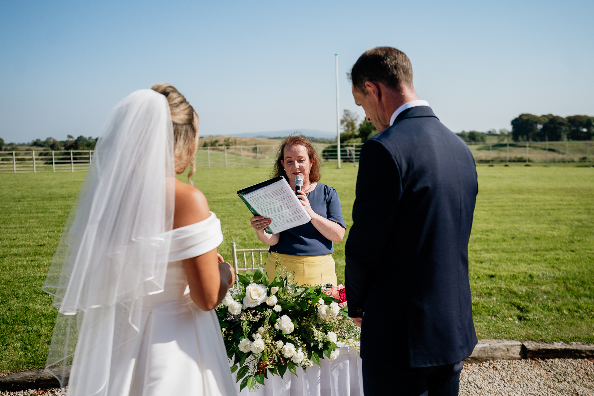 A bride and groom holding a bouquet