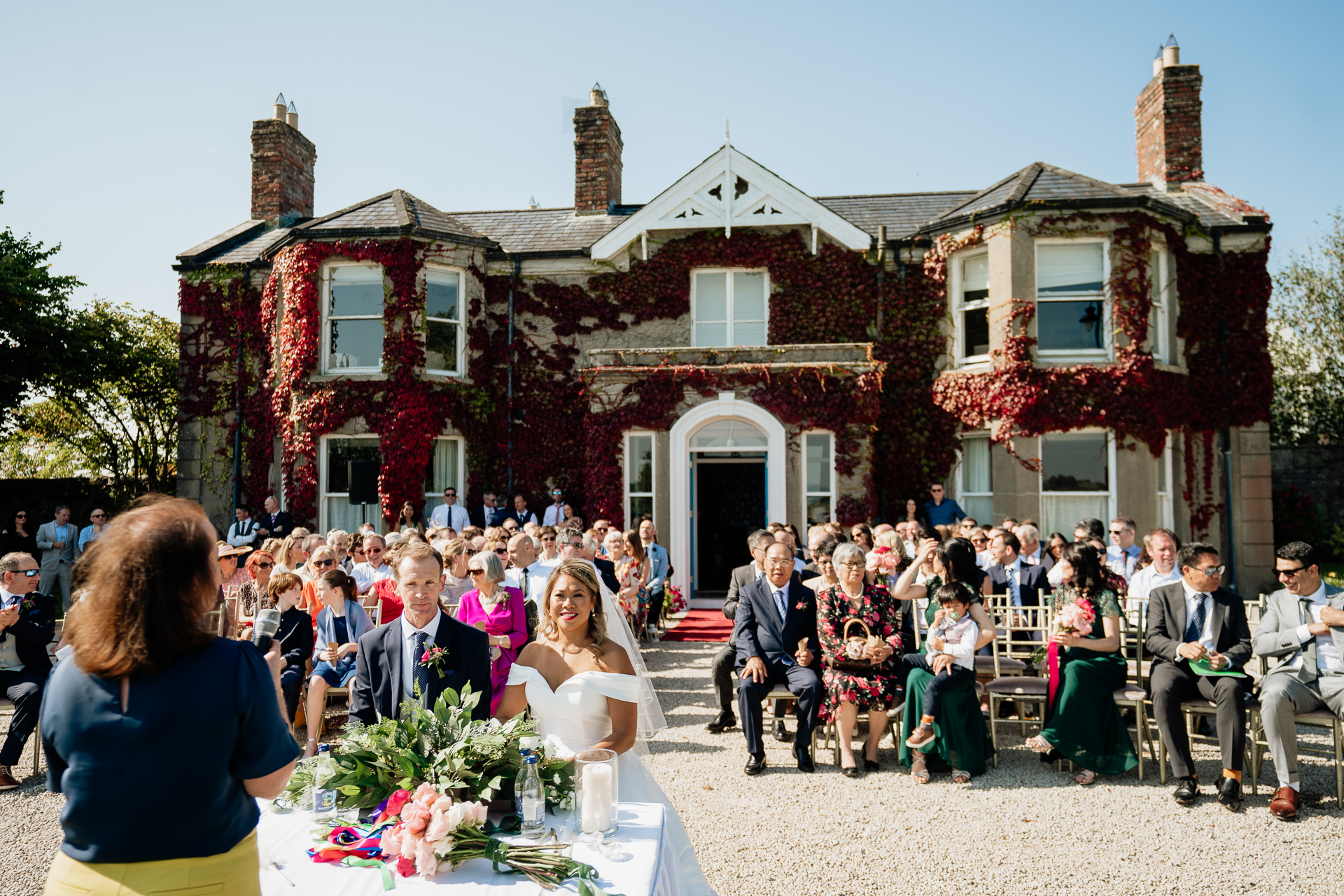 A wedding party in front of a house