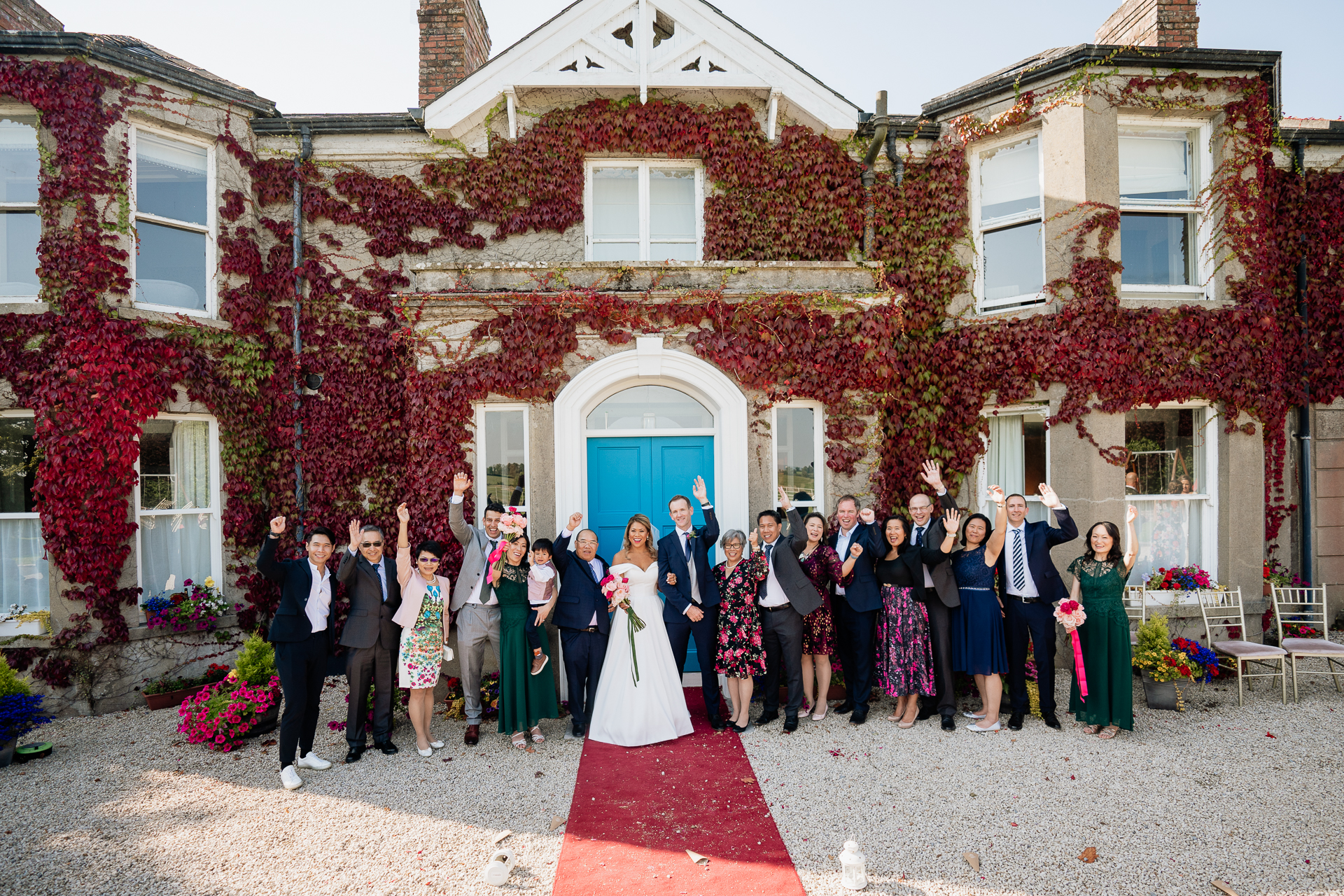 A group of people posing for a photo in front of a house