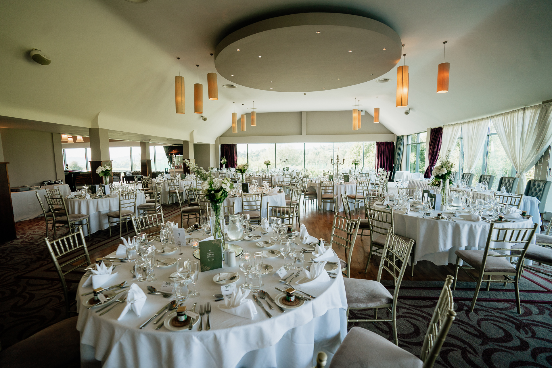 A large room with tables set for a meal