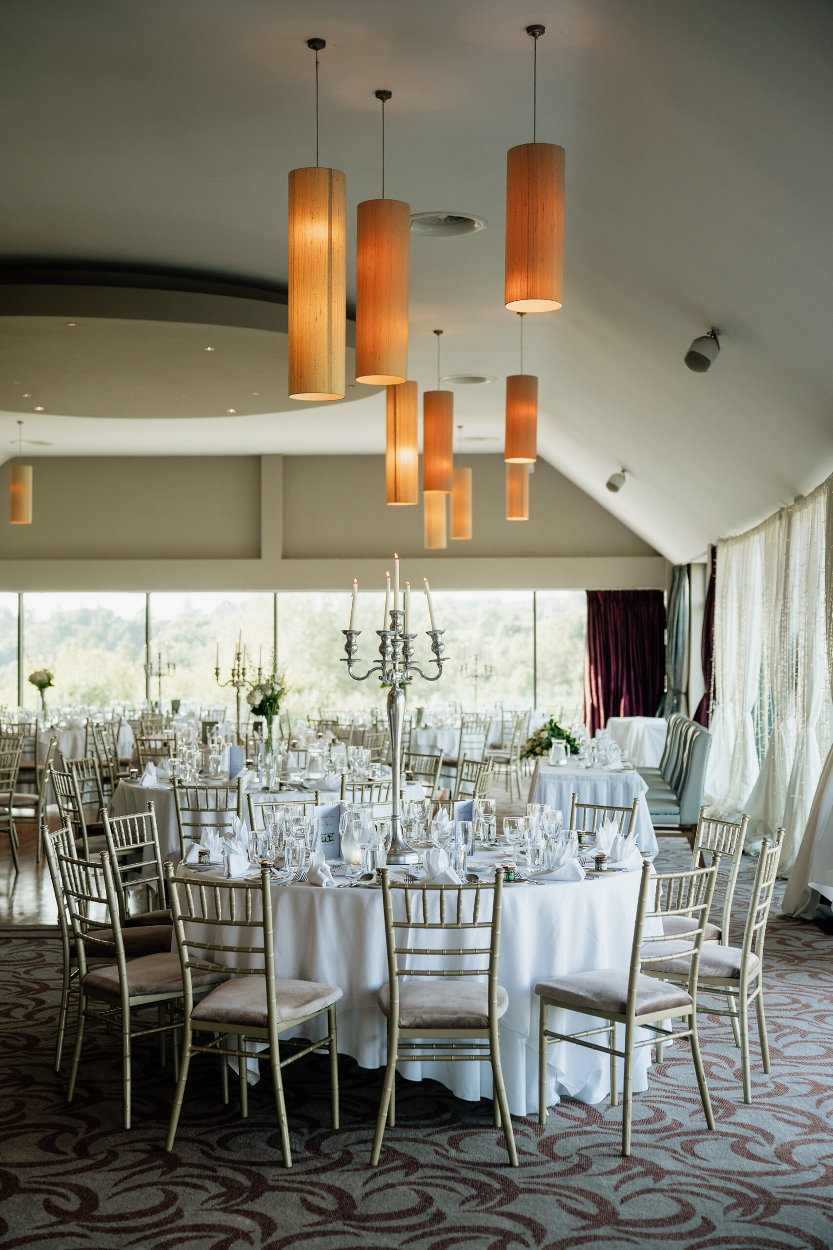 A dining room with a chandelier and chairs