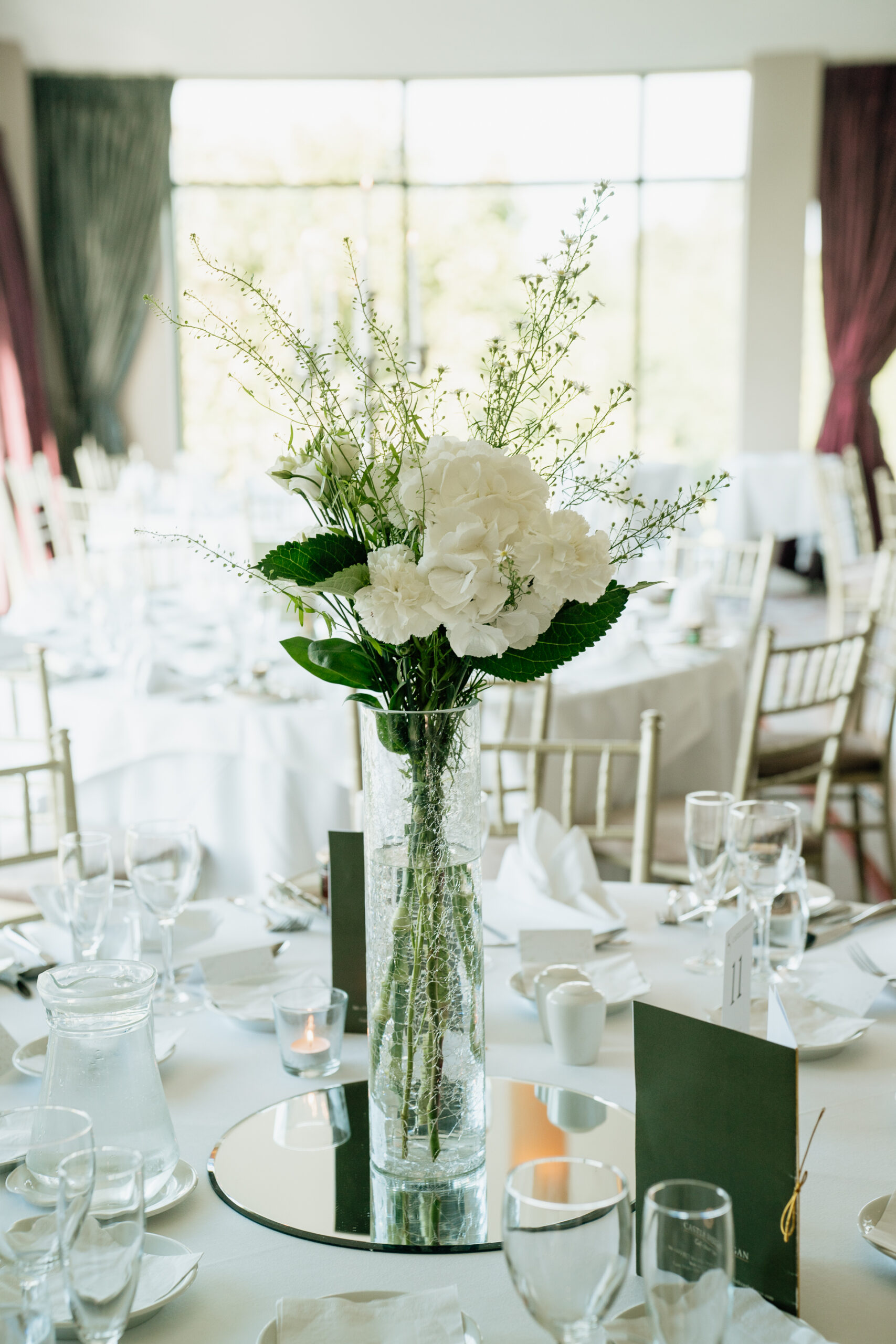 A vase with white flowers on a table