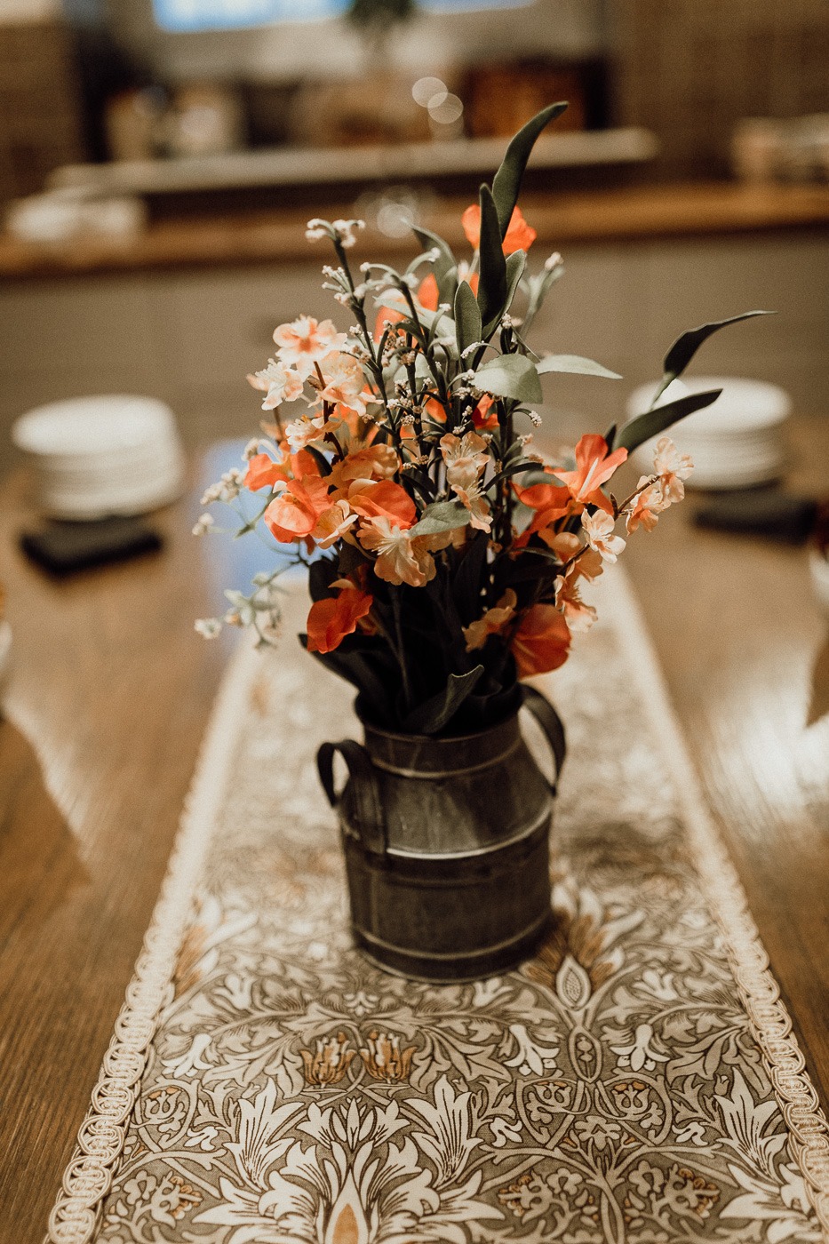 A vase filled with flowers sitting on top of a wooden table