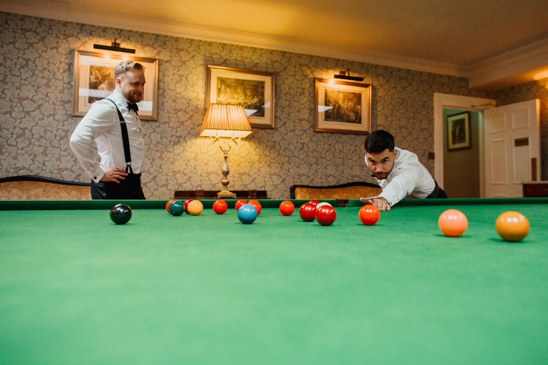 A couple of men playing pool