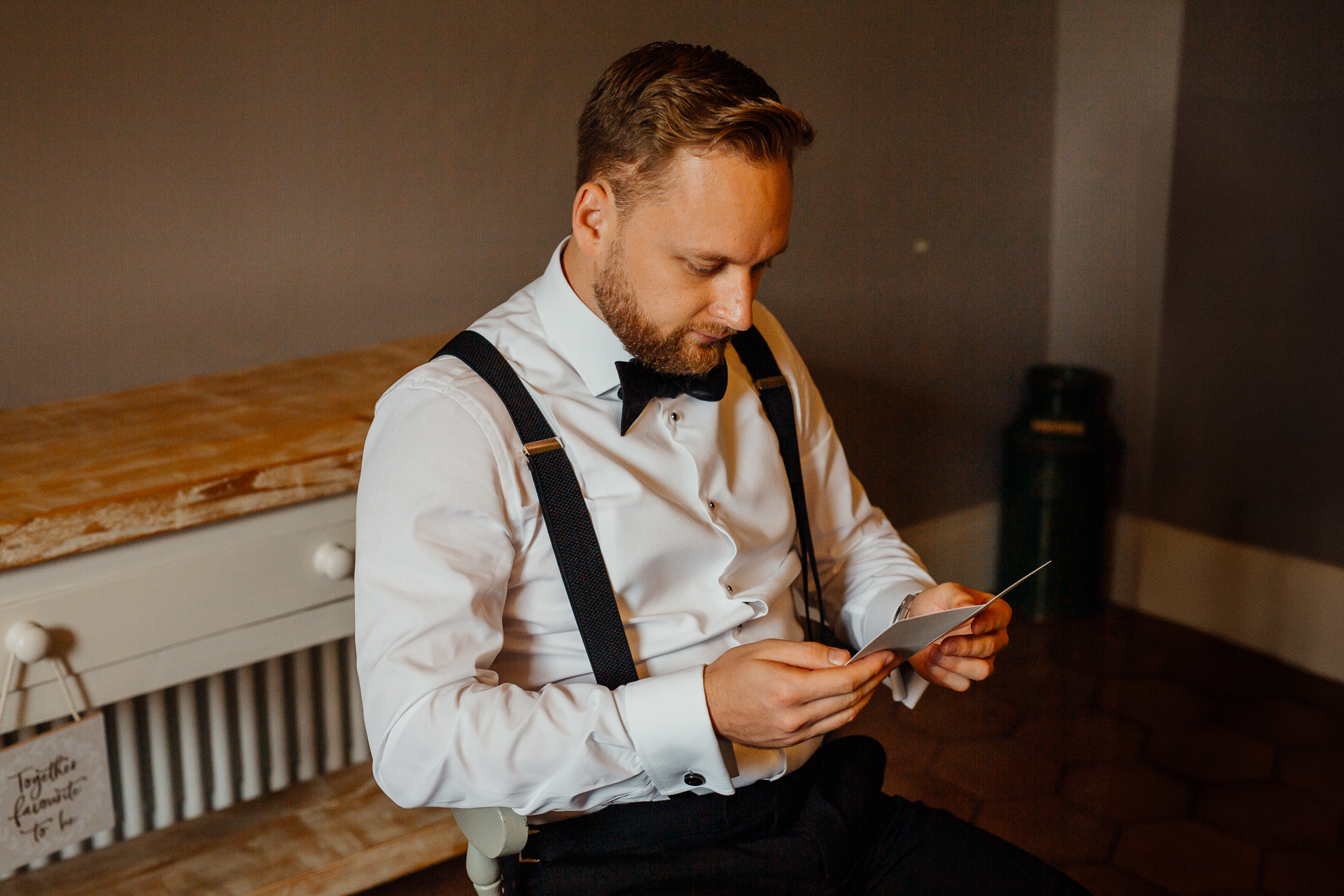 A man sitting on a bench looking at his phone