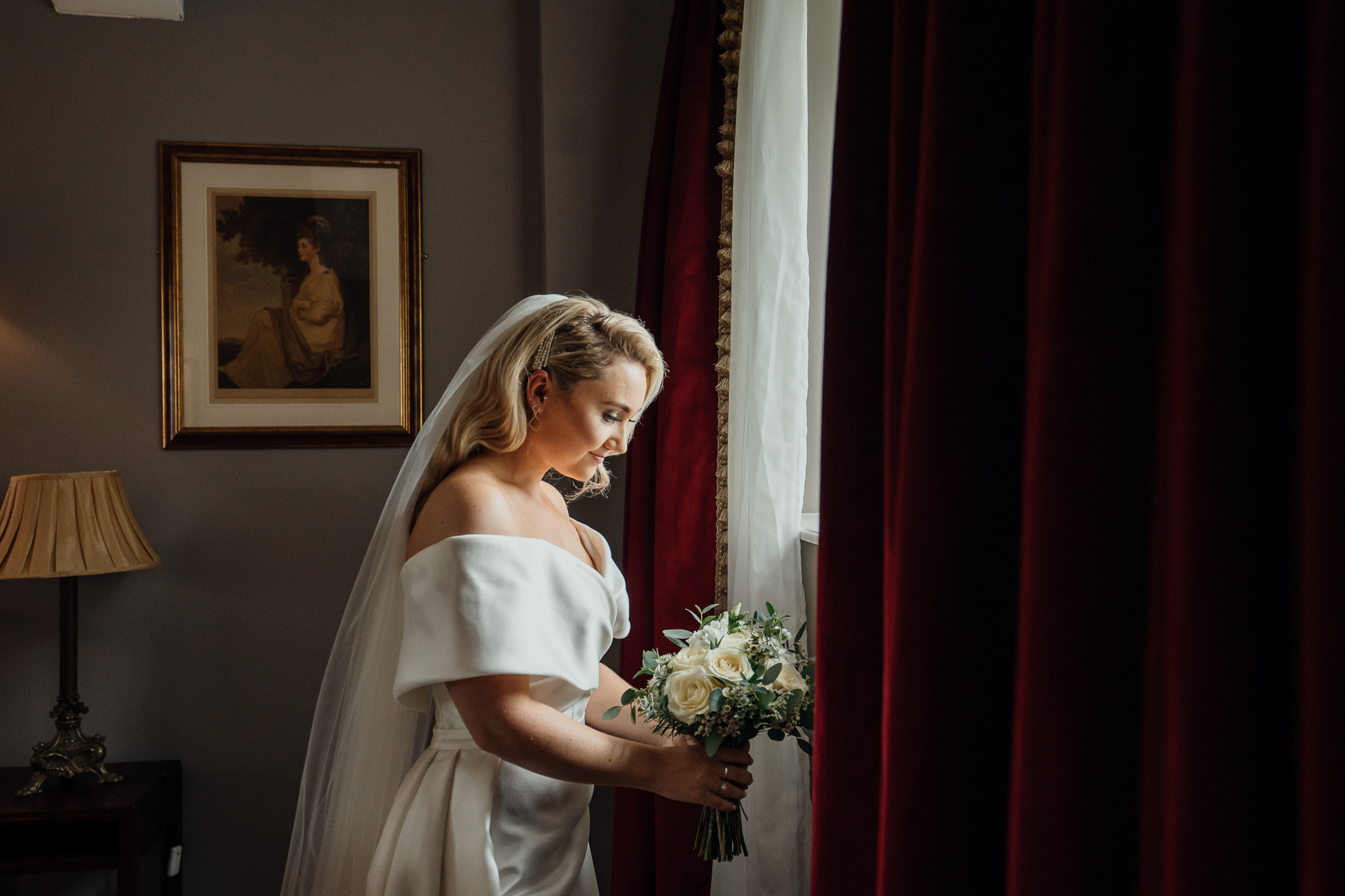 A person in a wedding dress holding a bouquet of flowers