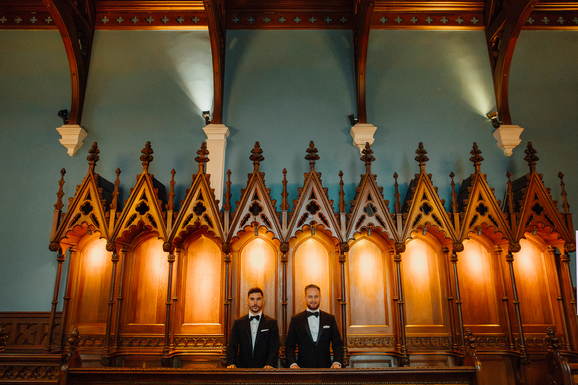 A couple of men standing on a stage in front of a large ornate building