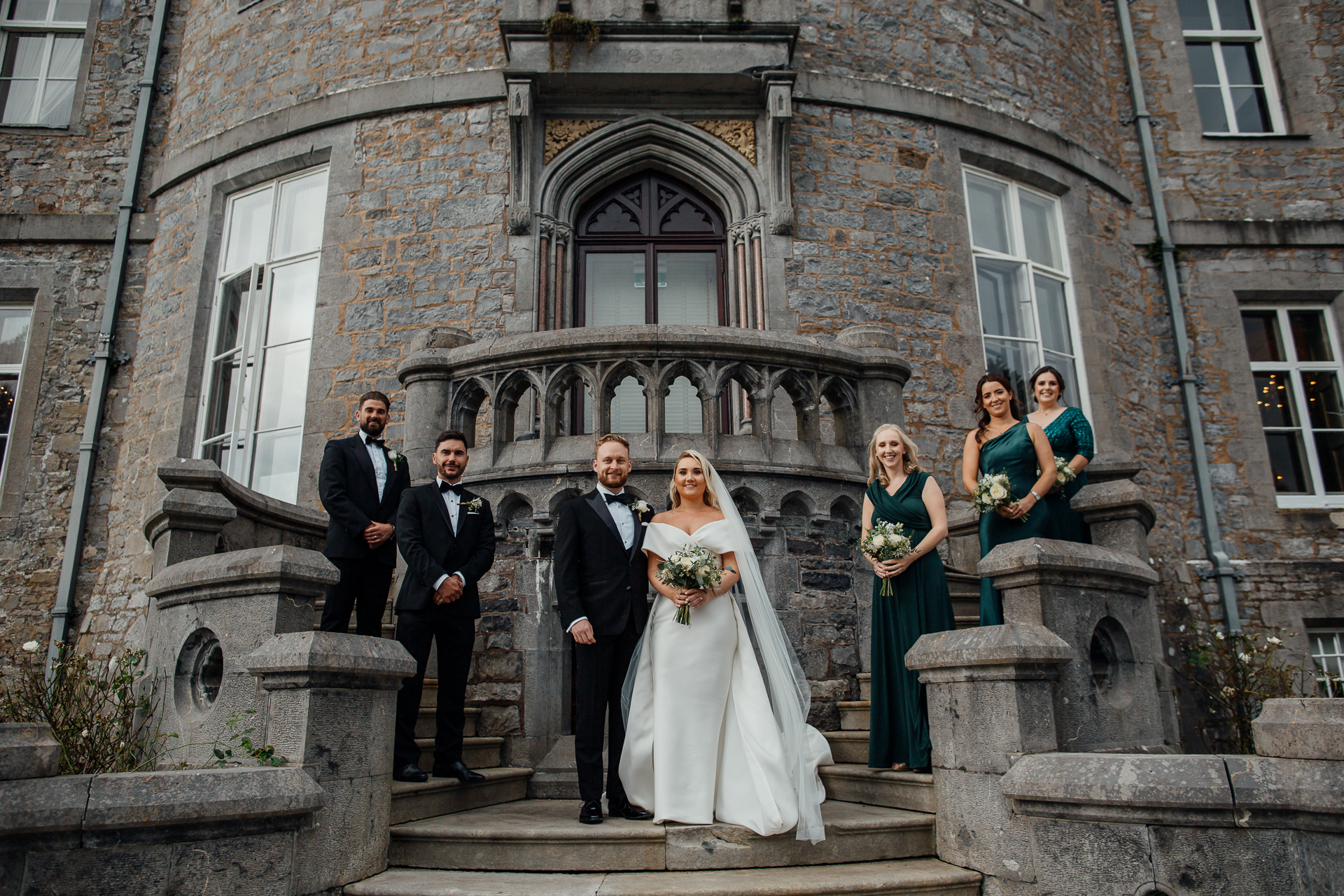 A group of people posing for a photo on steps outside a building