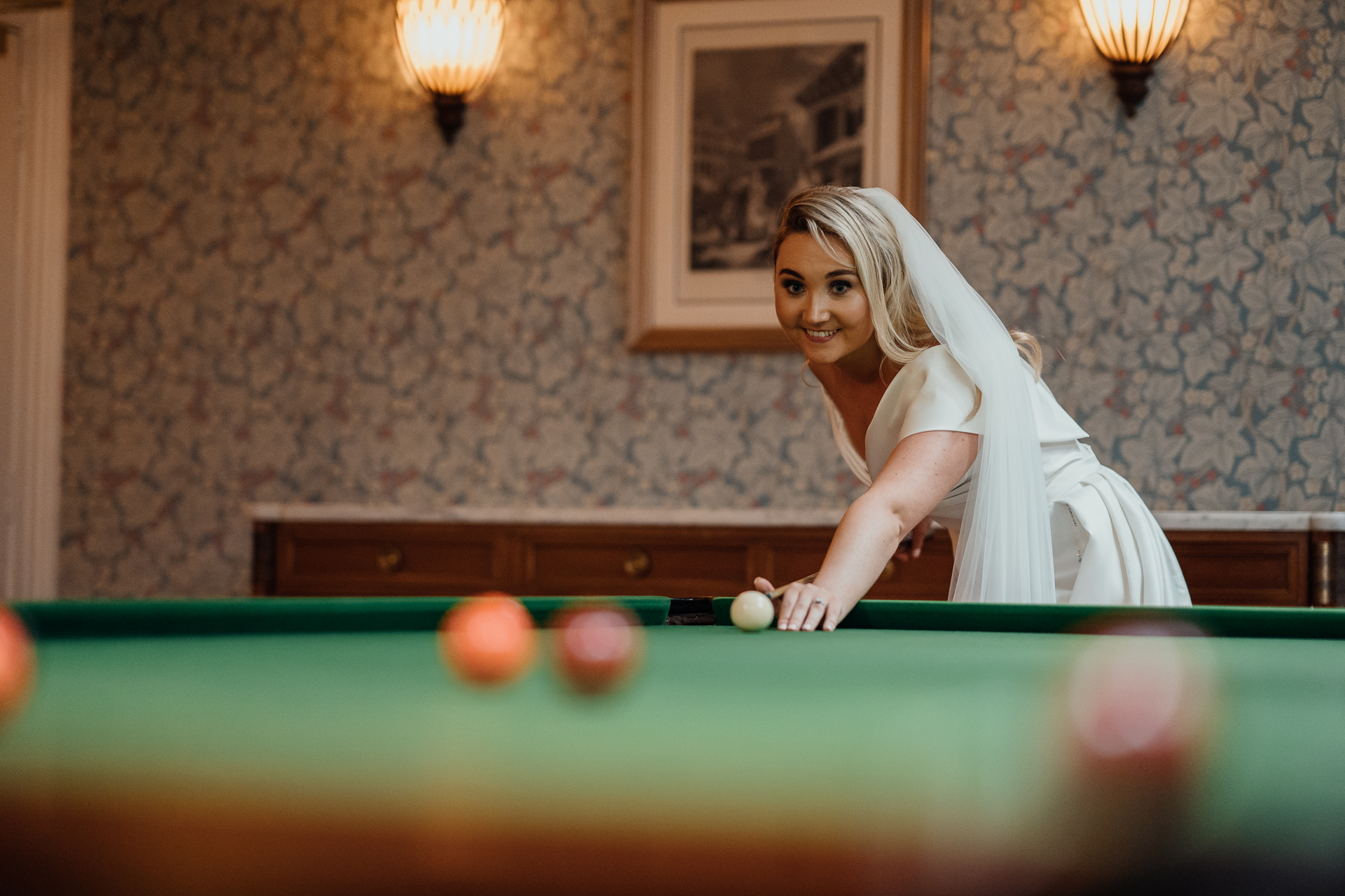 A woman playing pool