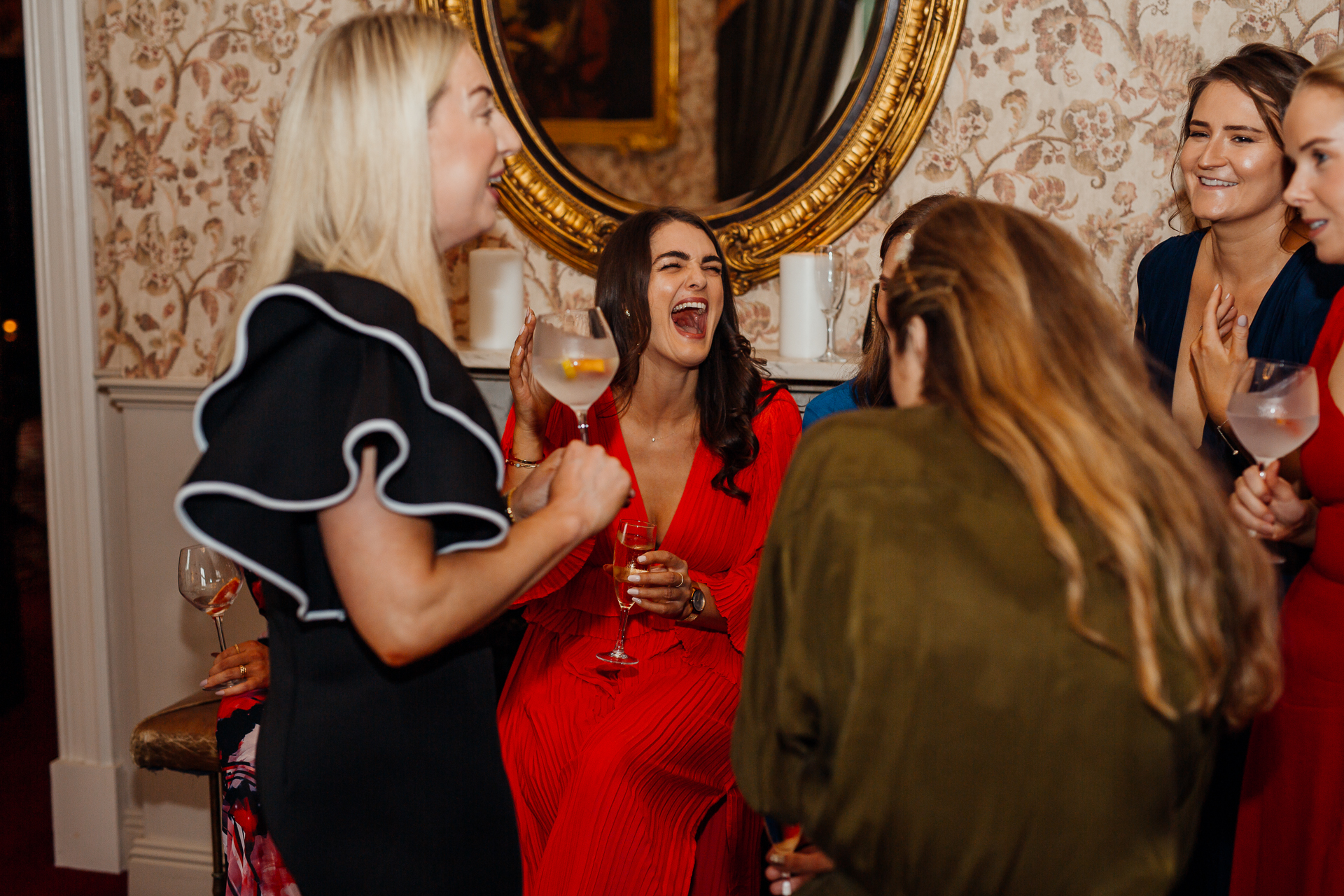 A group of women holding wine glasses