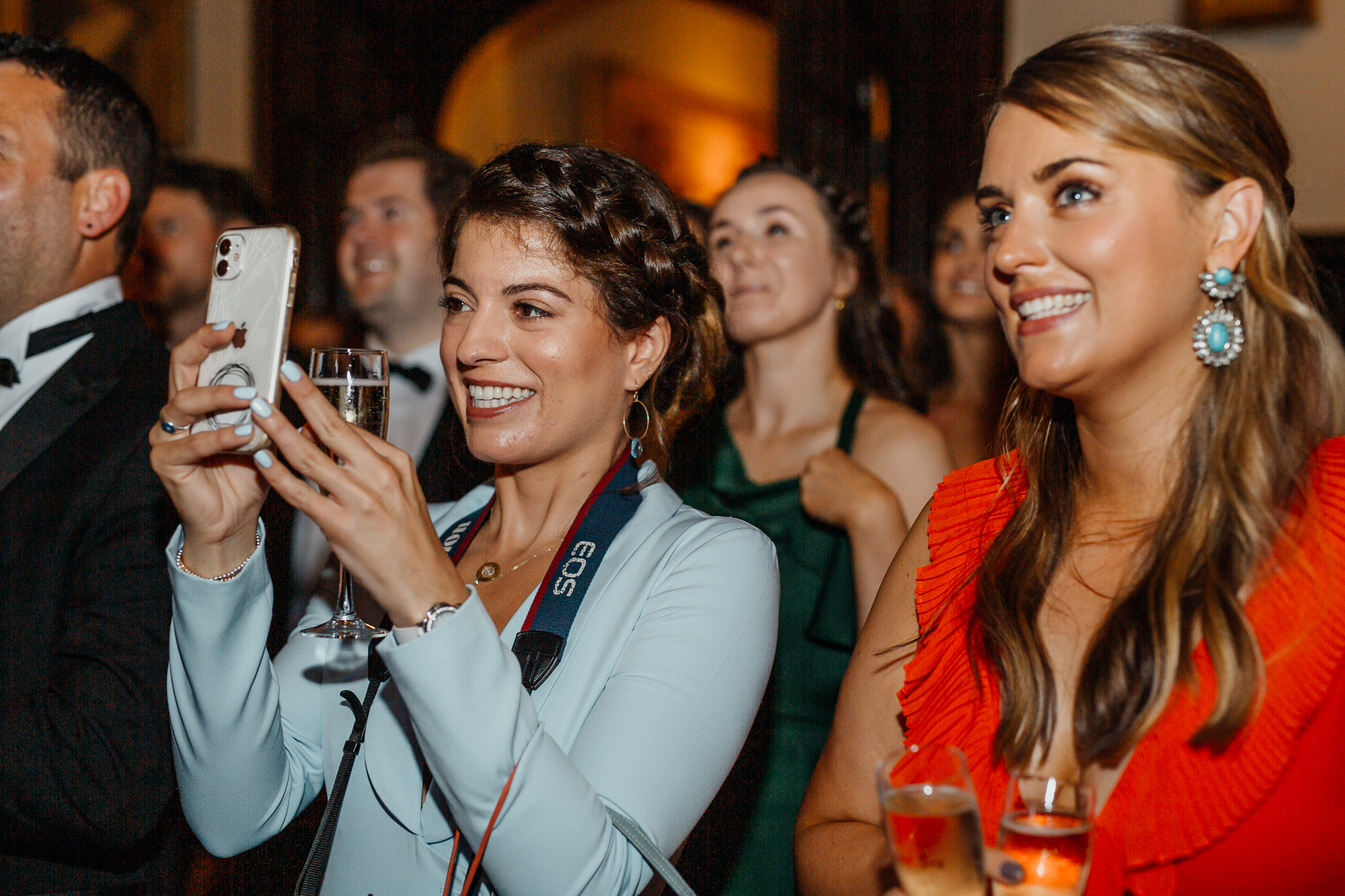 A few women smiling and holding glasses of wine