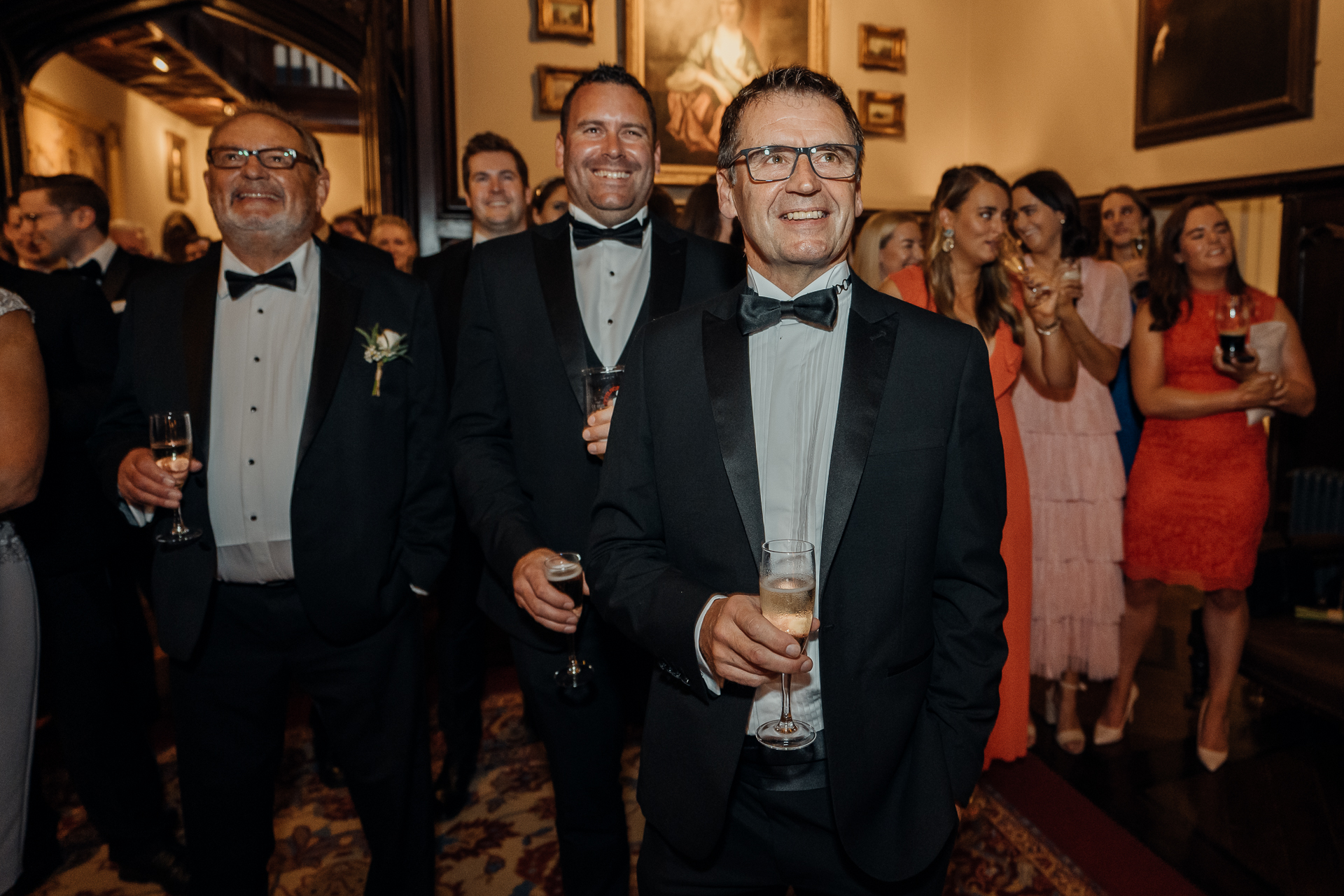 A group of men holding wine glasses