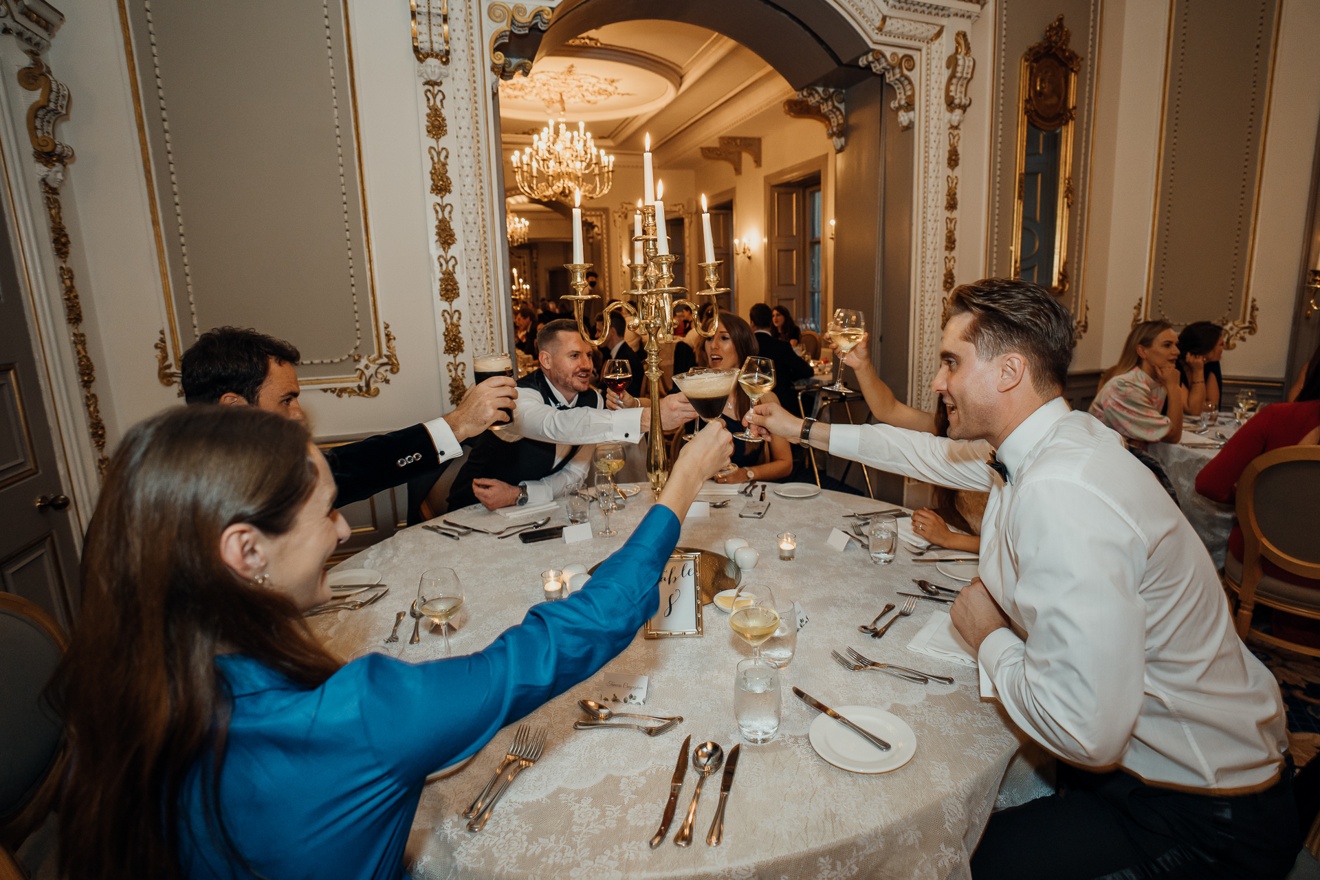 A group of people sitting at a table drinking wine