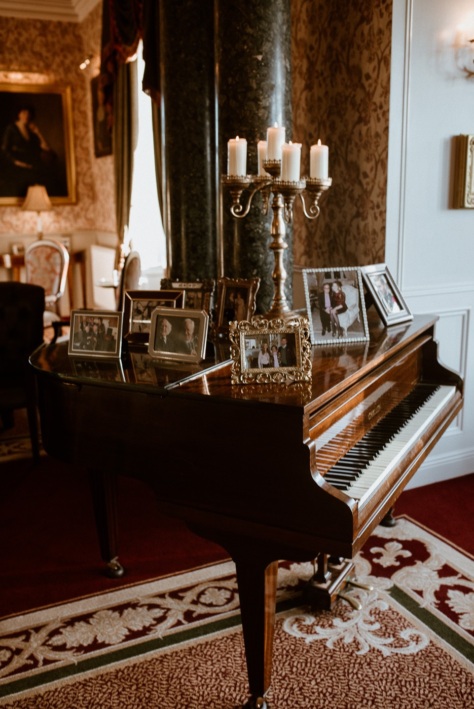 A piano next to a fireplace in a living room
