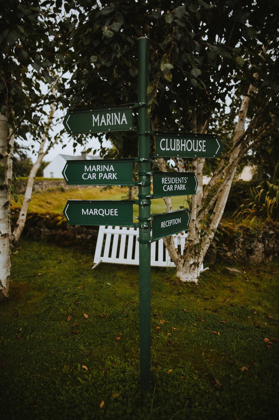 A close up of a street sign with trees in the background